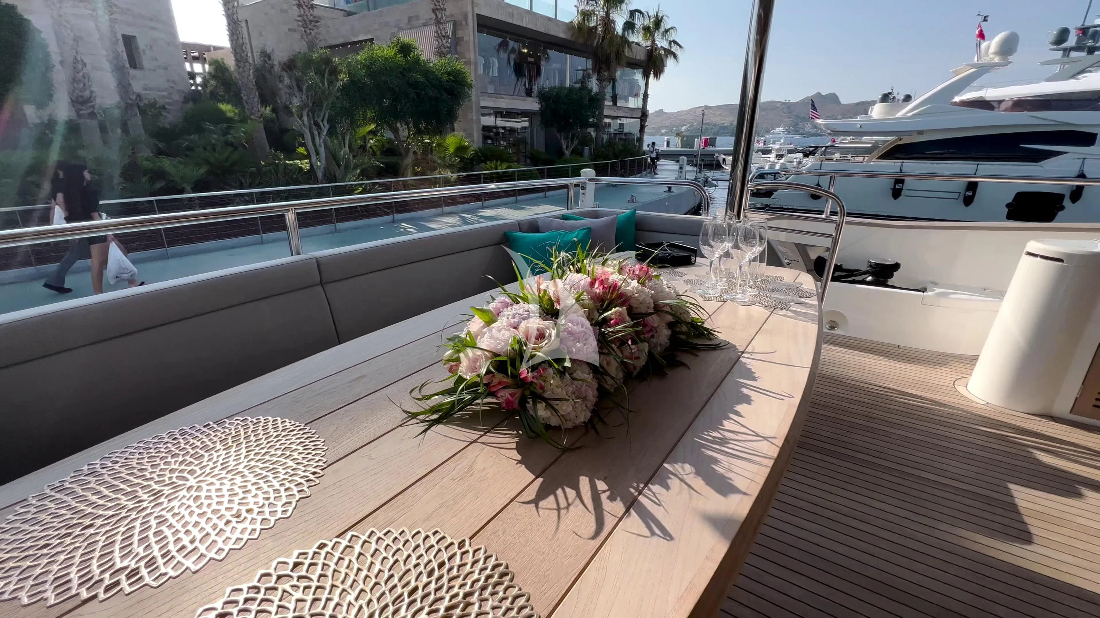 a table with flowers on it aboard NEW EDGE Yacht for Sale