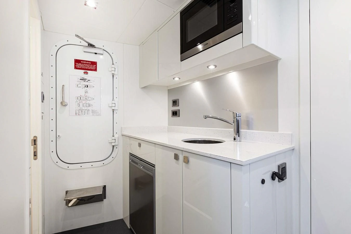 a white refrigerator in a kitchen aboard NEW EDGE Yacht for Sale