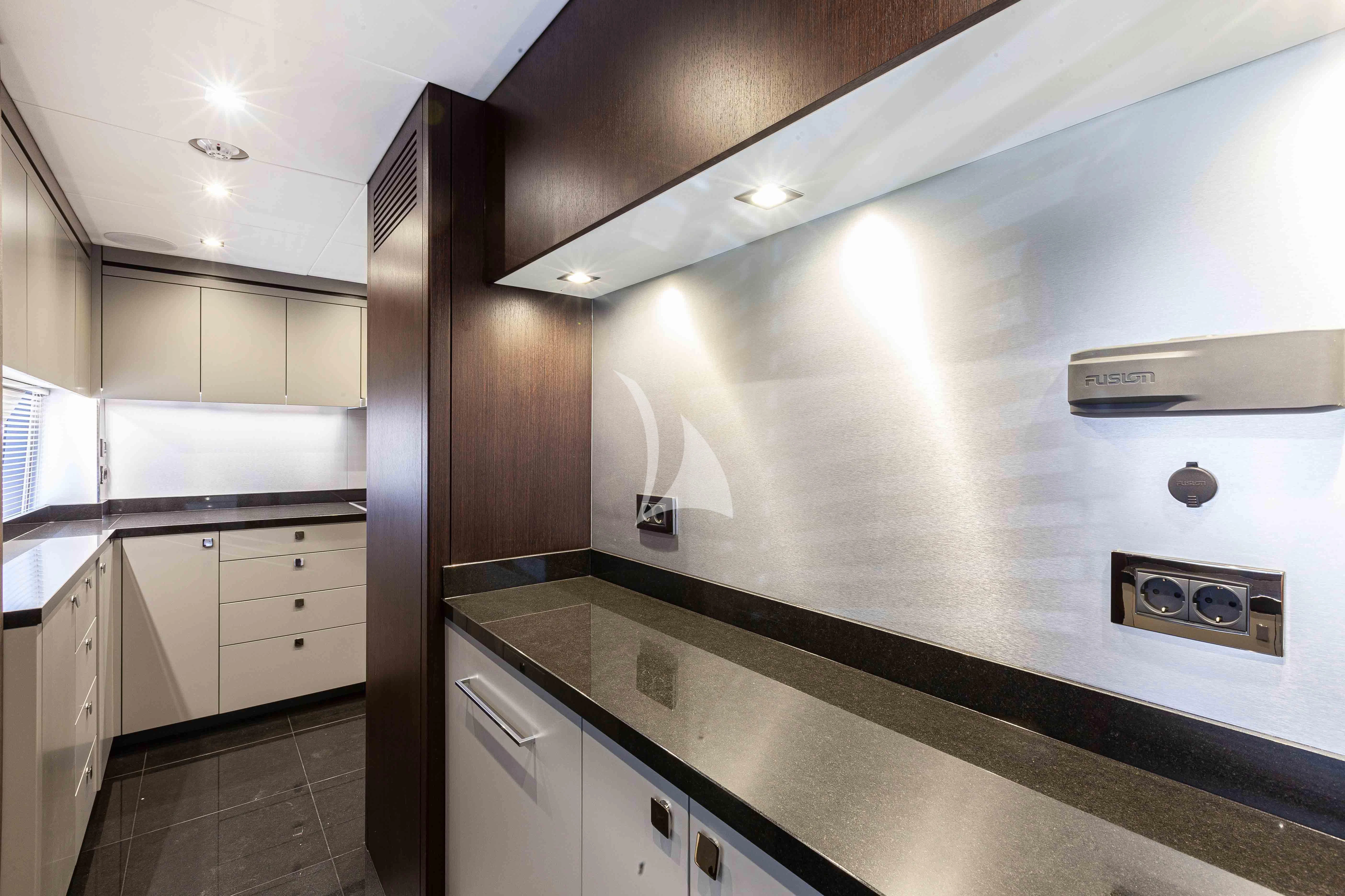 a kitchen with white cabinets aboard NEW EDGE Yacht for Sale