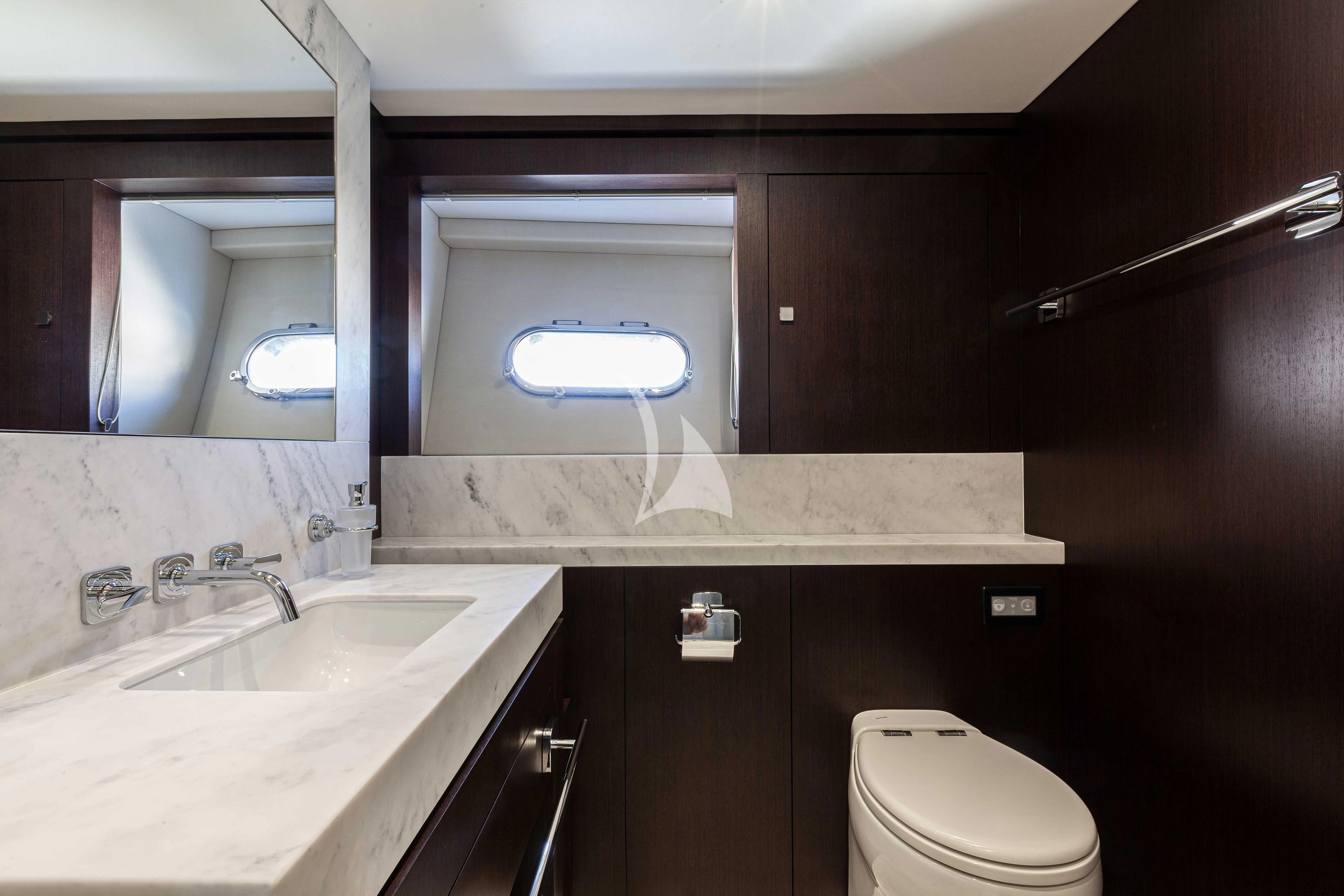 a bathroom with a toilet and a sink aboard NEW EDGE Yacht for Sale