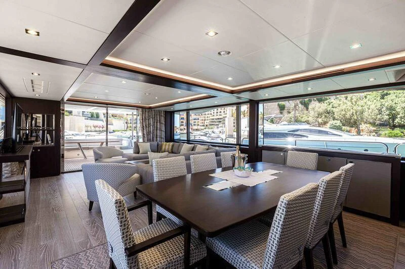 a large dining table on a deck aboard NEW EDGE Yacht for Sale