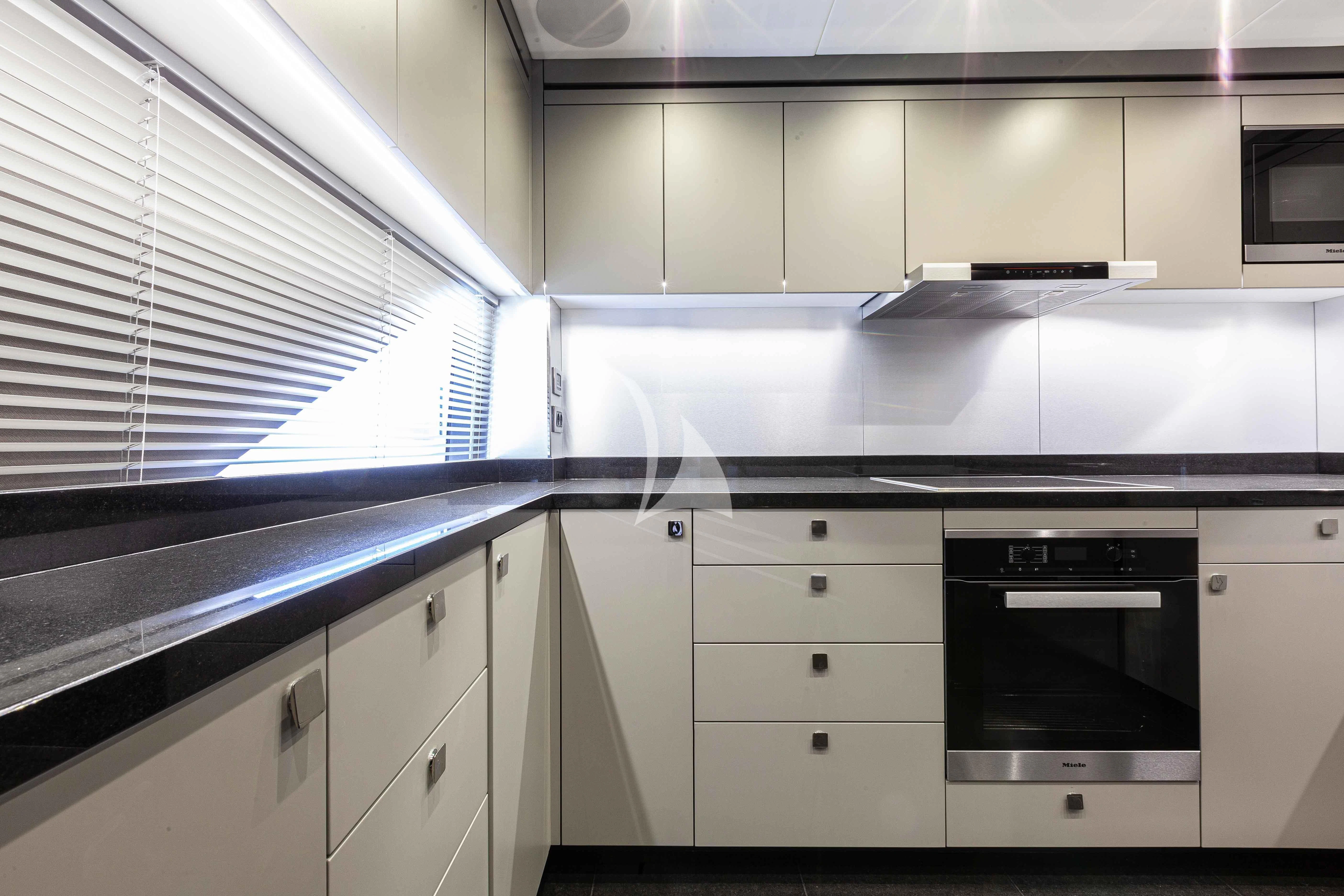a kitchen with white cabinets aboard NEW EDGE Yacht for Sale