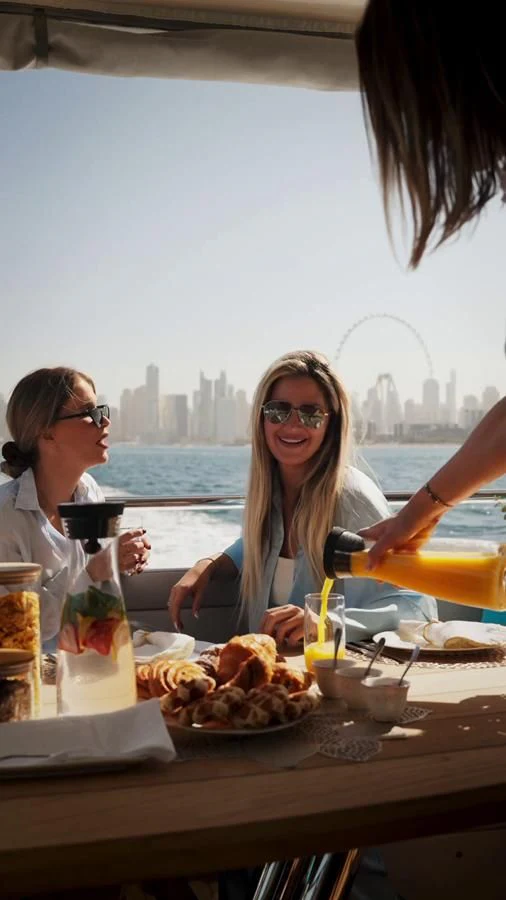 a group of women eating at a table aboard NEW EDGE Yacht for Sale