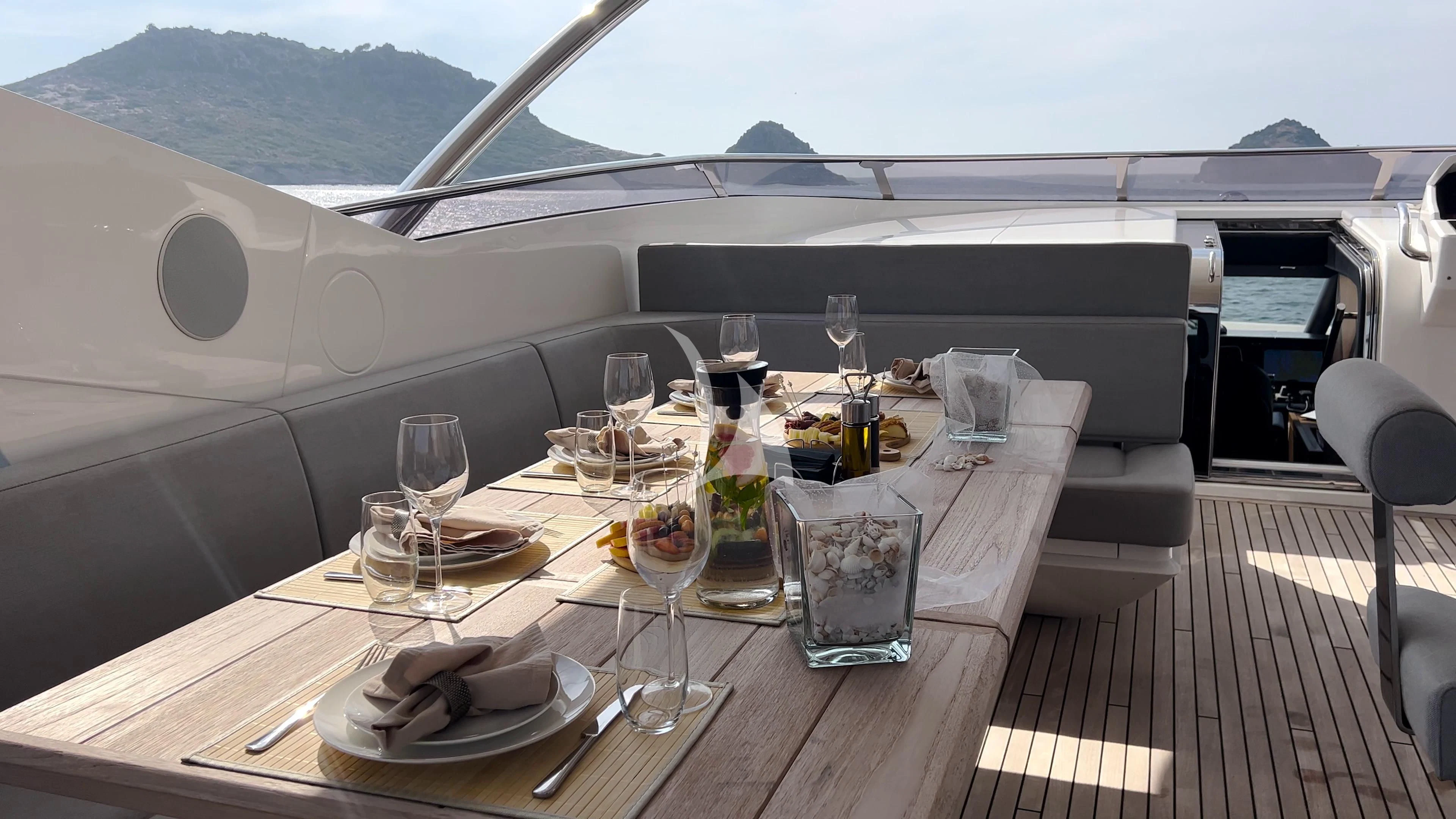 a table with wine glasses and food on it aboard NEW EDGE Yacht for Sale