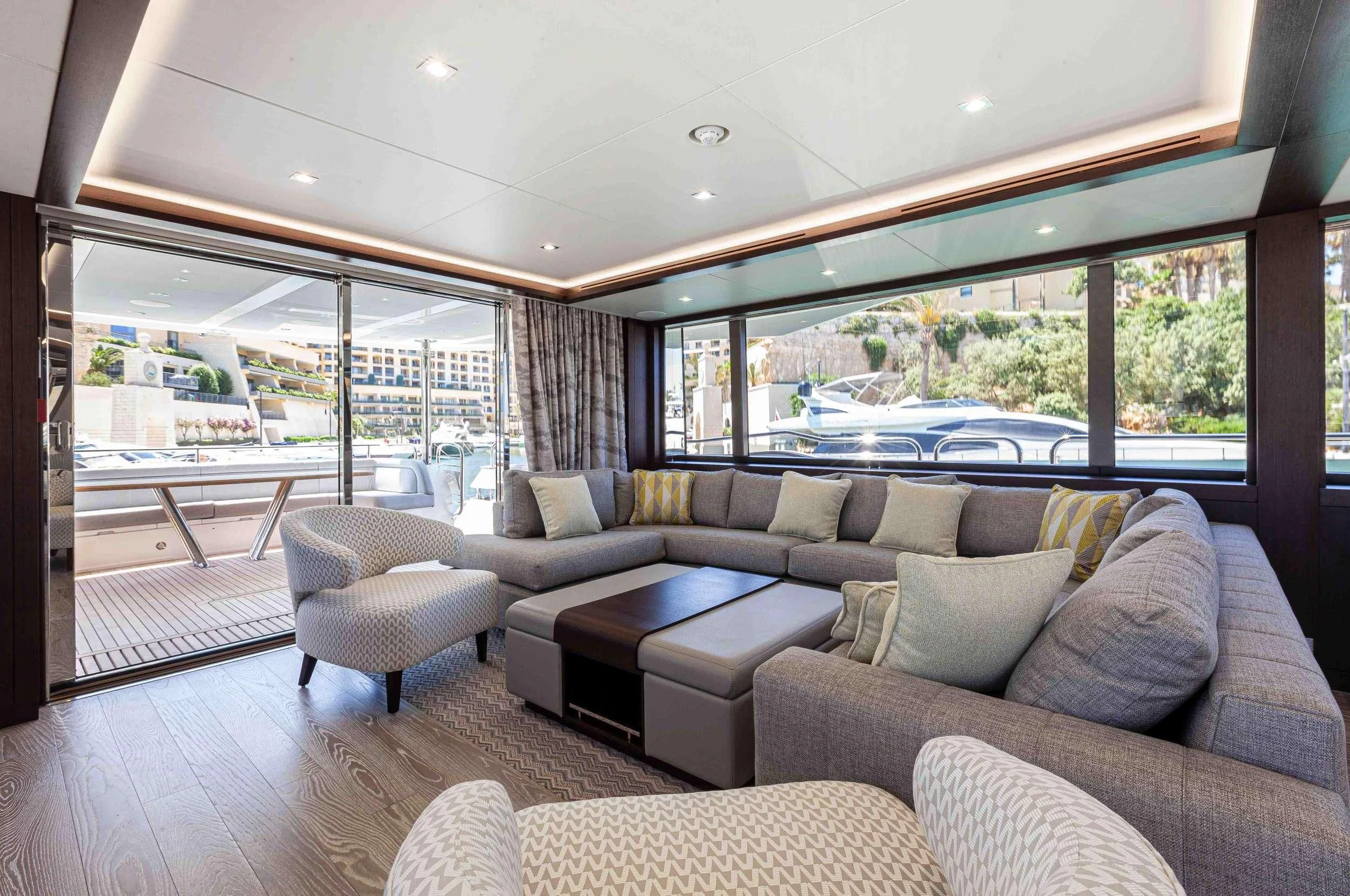 a living room with a large window aboard NEW EDGE Yacht for Sale