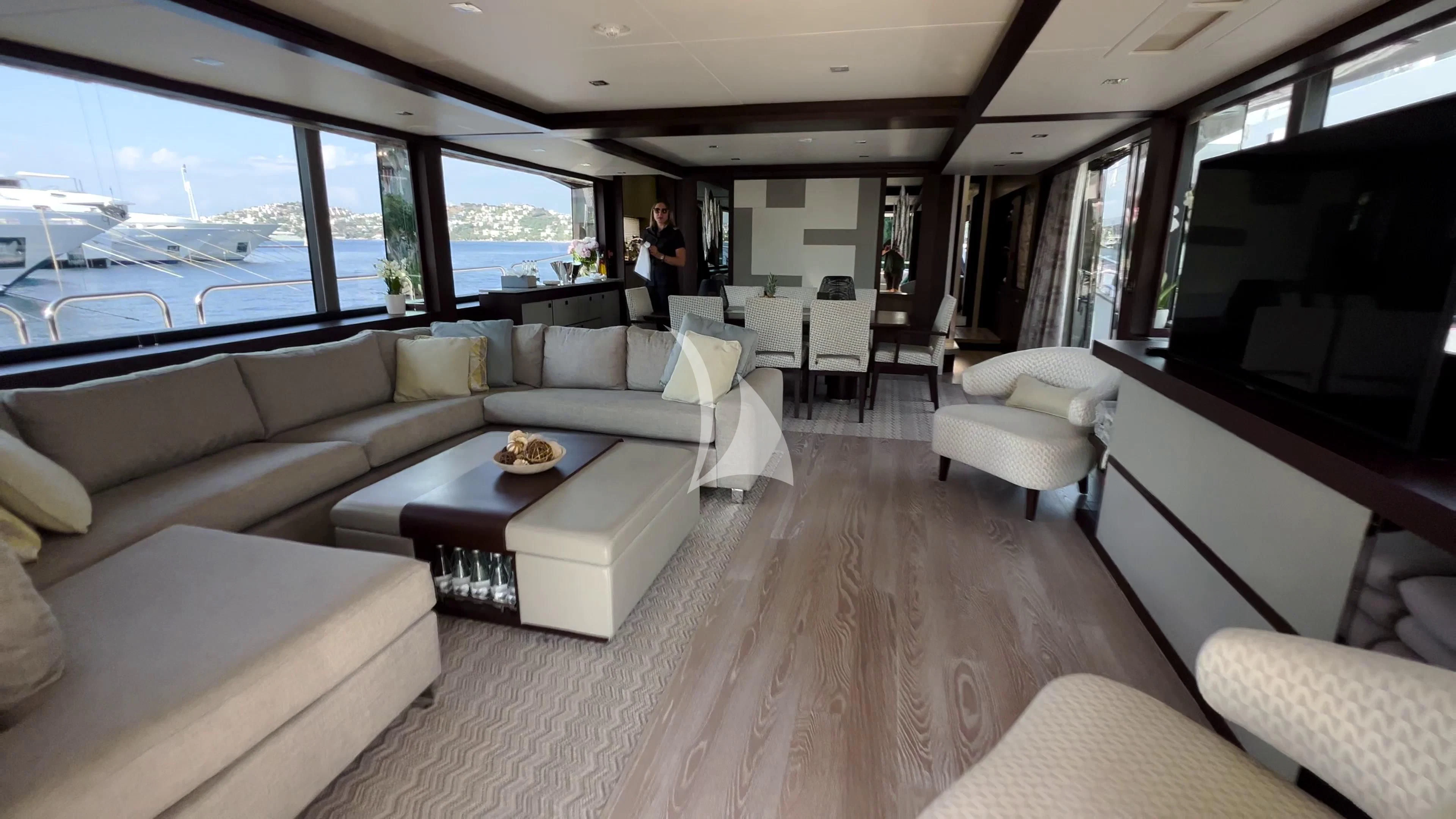 a room with a couch and a table and a television aboard NEW EDGE Yacht for Sale