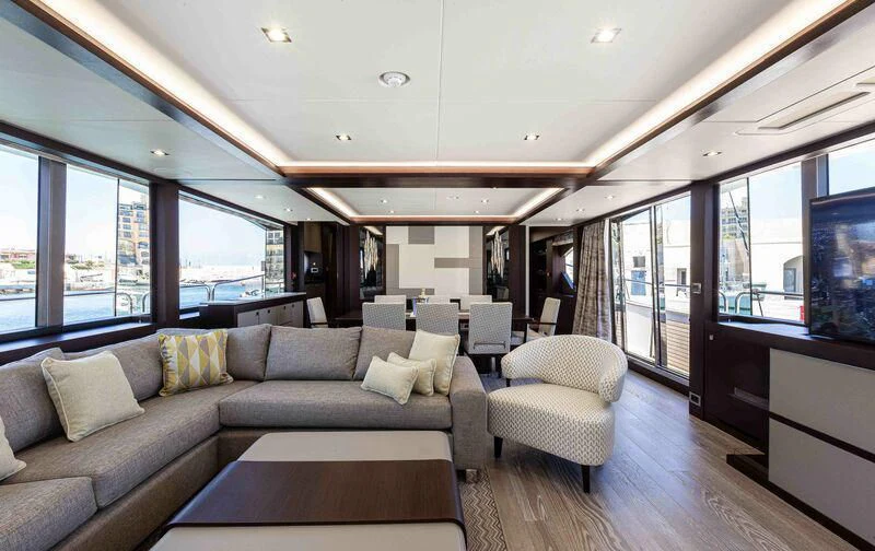 a living room with a couch and a table aboard NEW EDGE Yacht for Sale