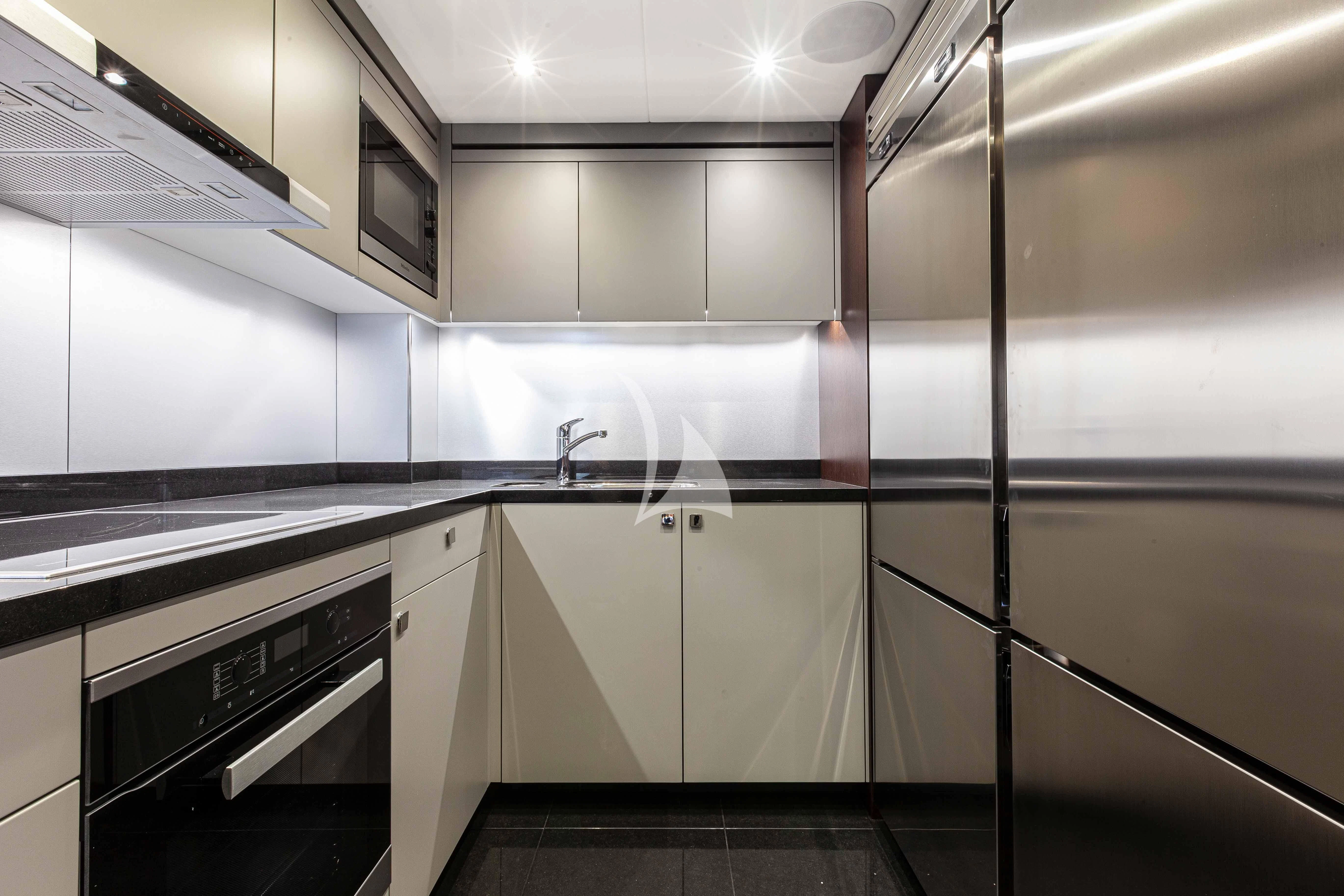 a kitchen with white cabinets aboard NEW EDGE Yacht for Sale