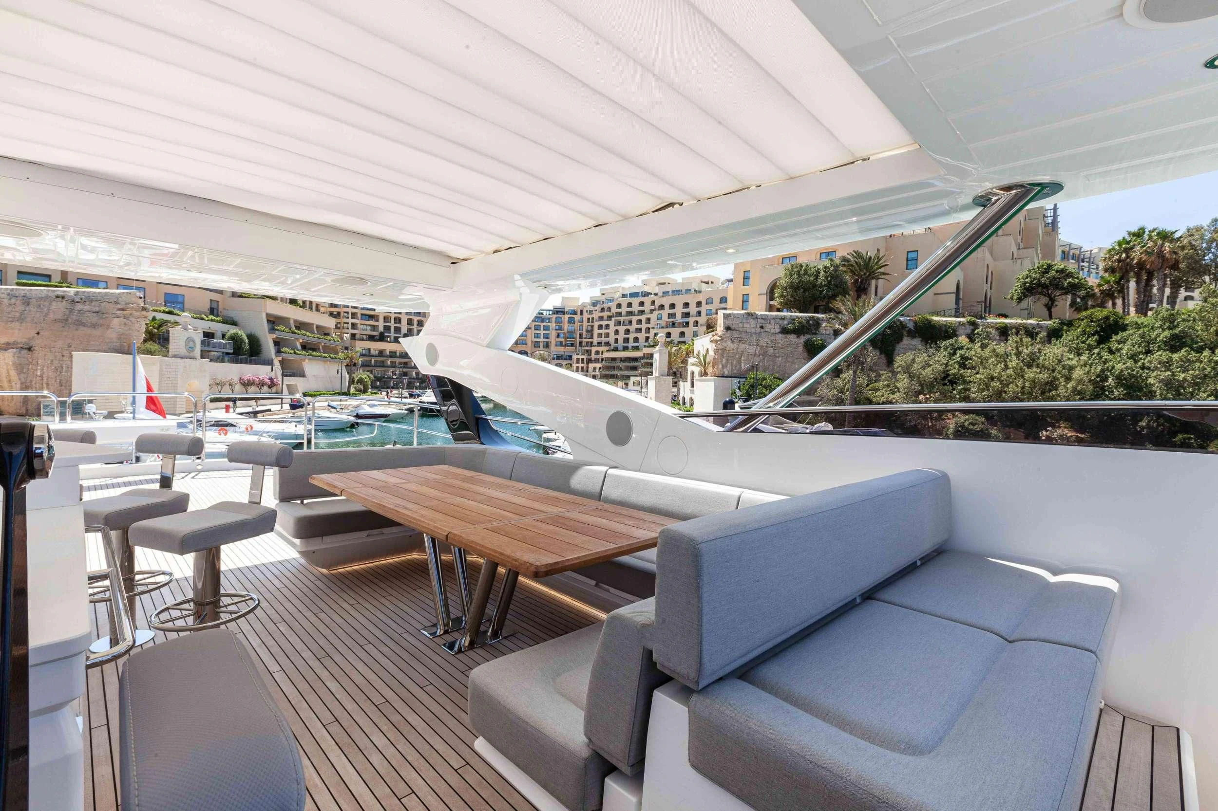 a room with a table and chairs aboard NEW EDGE Yacht for Sale