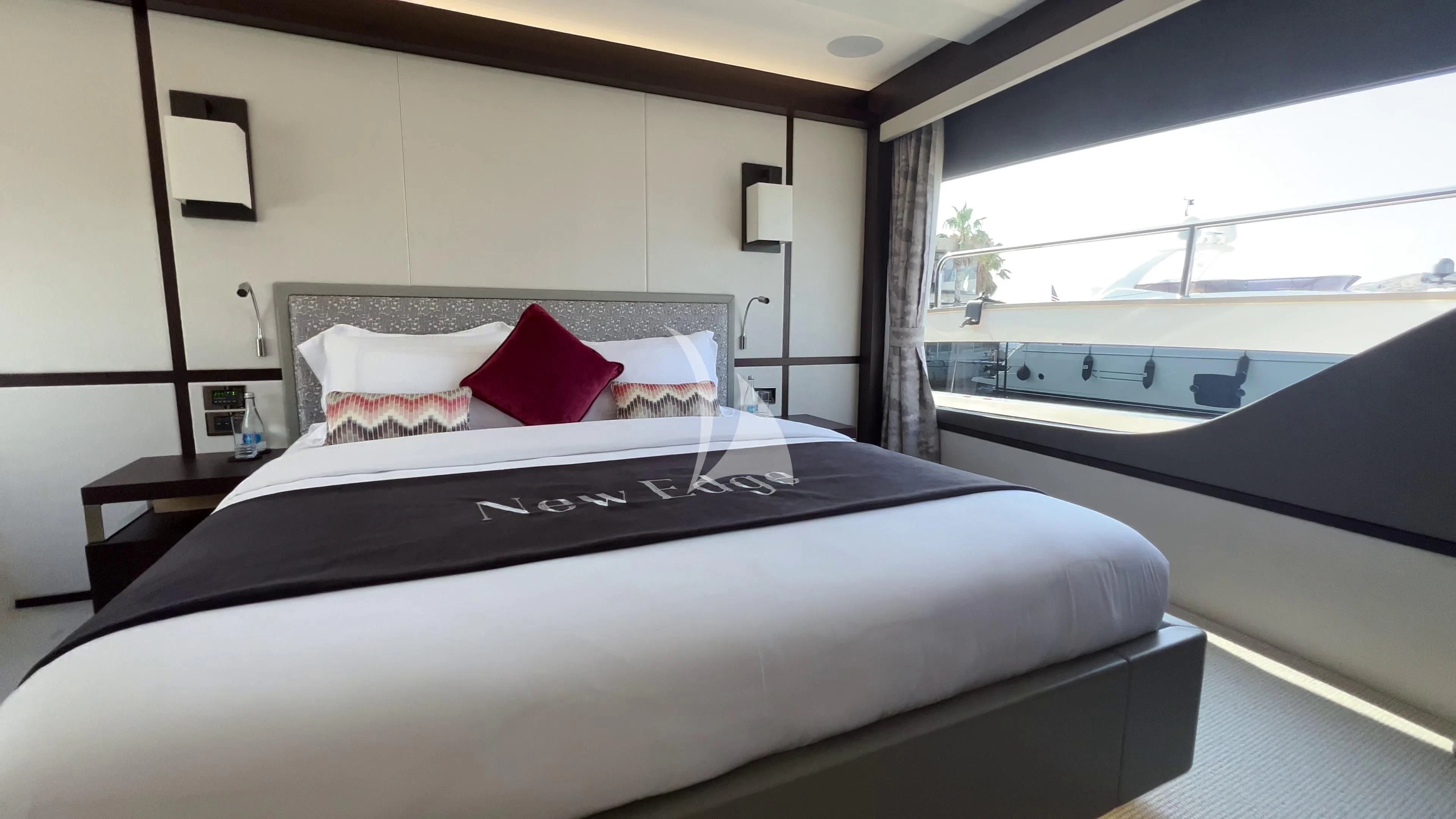 a bed with a black and white bed spread aboard NEW EDGE Yacht for Sale