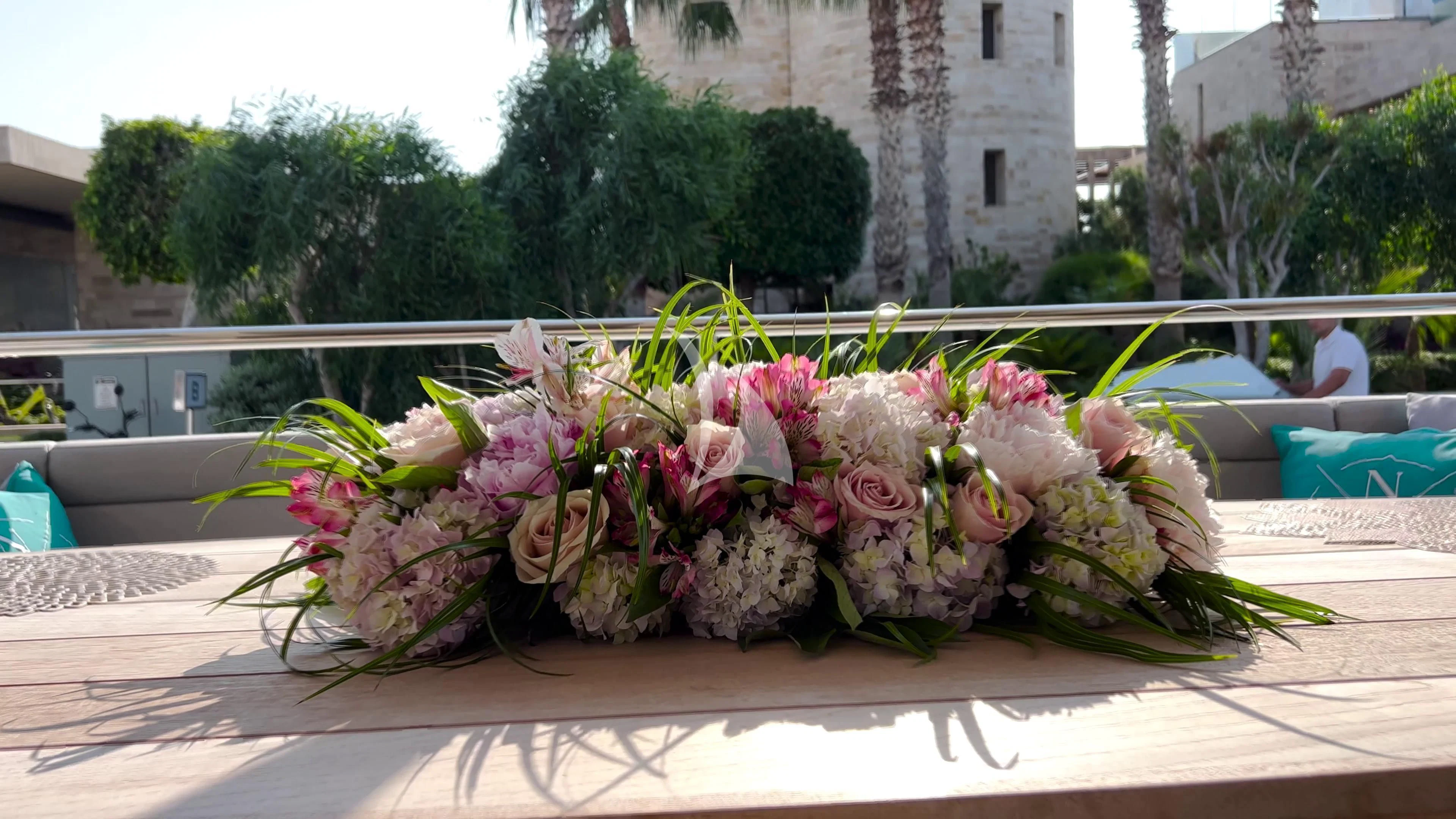a group of flowers on a table aboard NEW EDGE Yacht for Sale