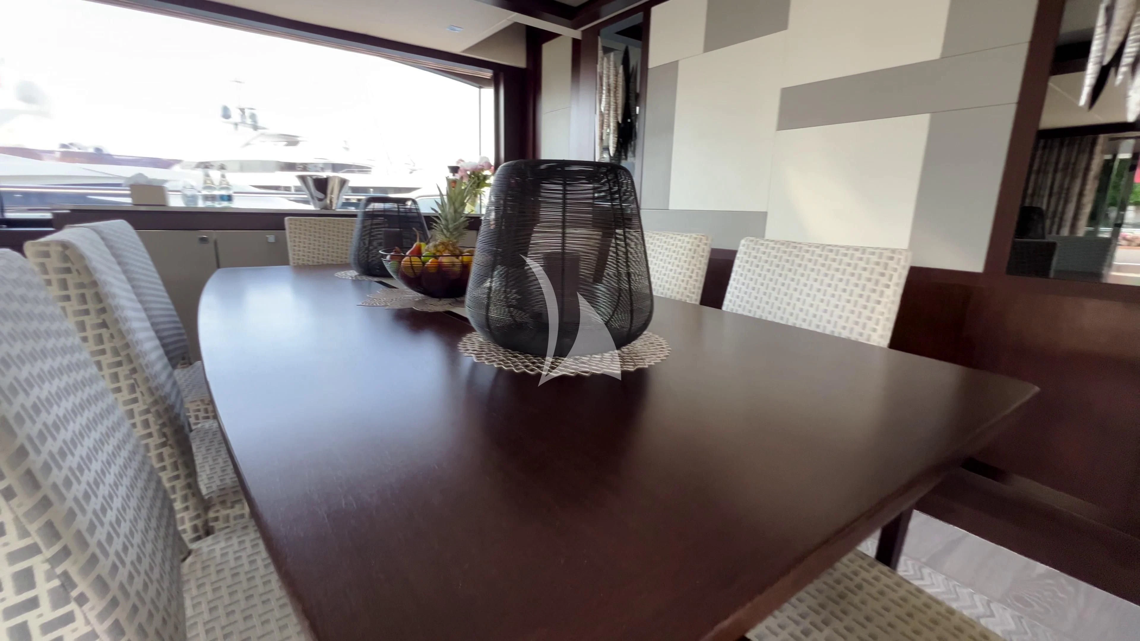 a dining table with a fan aboard NEW EDGE Yacht for Sale