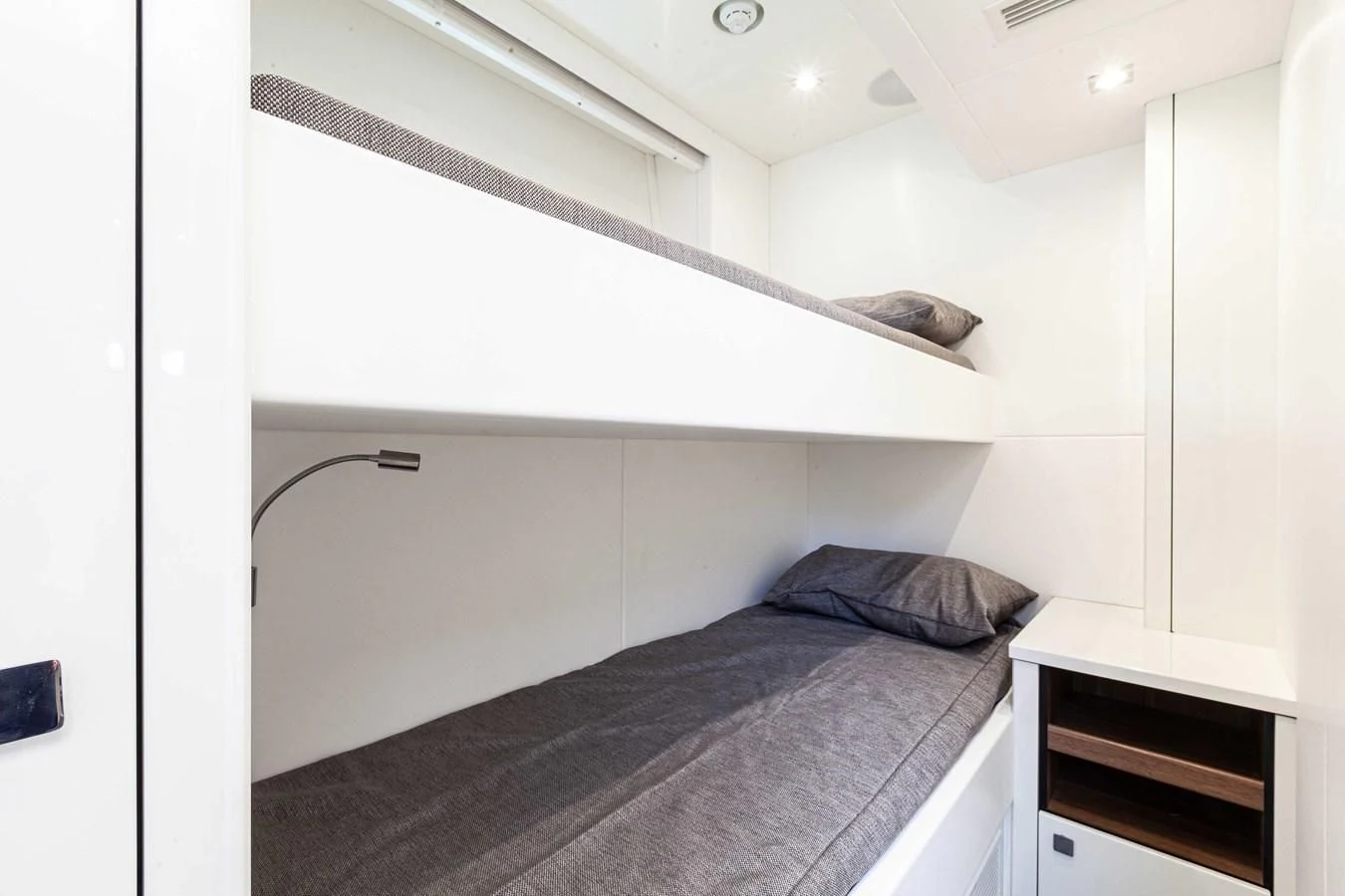 a bed with a black comforter aboard NEW EDGE Yacht for Sale