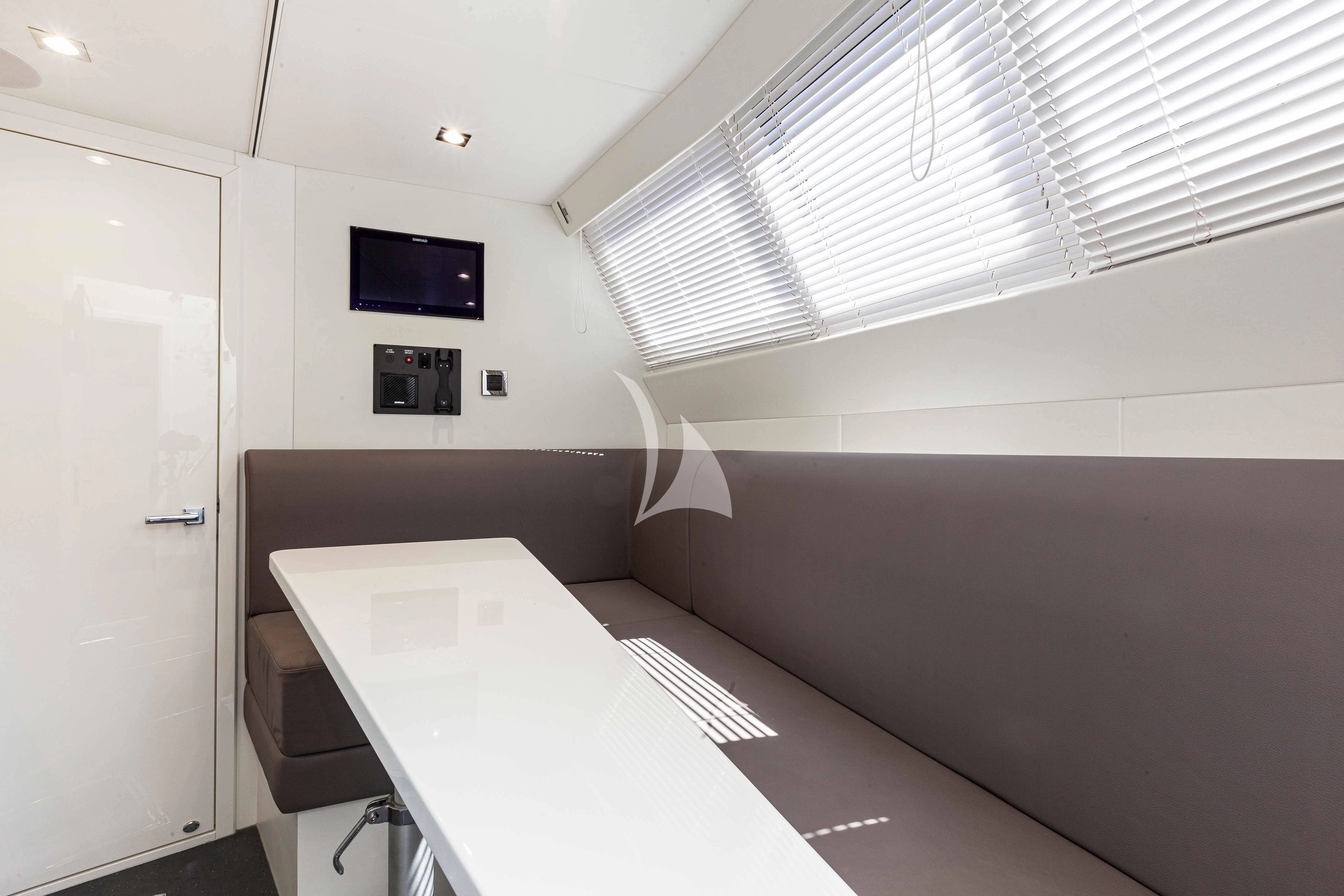 a room with a tv and a window aboard NEW EDGE Yacht for Sale
