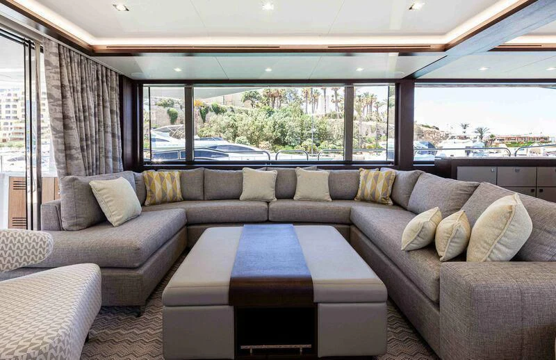 a couch with a table in front of it aboard NEW EDGE Yacht for Sale