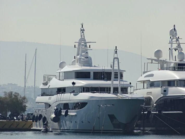 a large white boat sits in a harbor aboard TACANUYASO M S Yacht for Sale