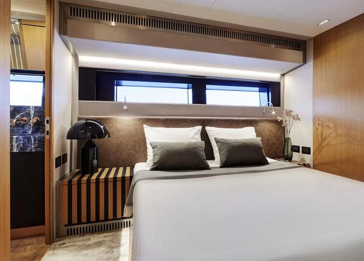 a bed with a white bed aboard BLUE JEANS Yacht for Sale