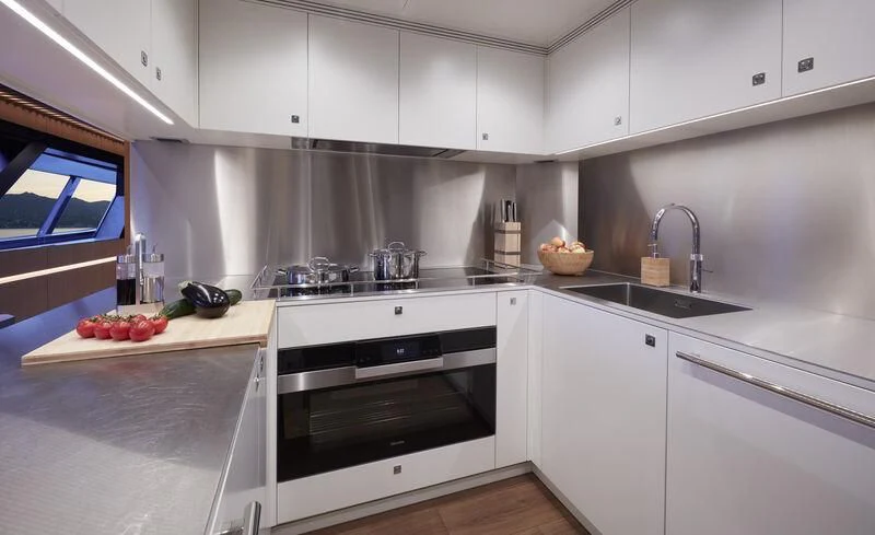 a kitchen with white cabinets aboard BLUE JEANS Yacht for Sale