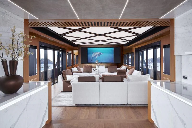 a living room with a large screen aboard BLUE JEANS Yacht for Sale
