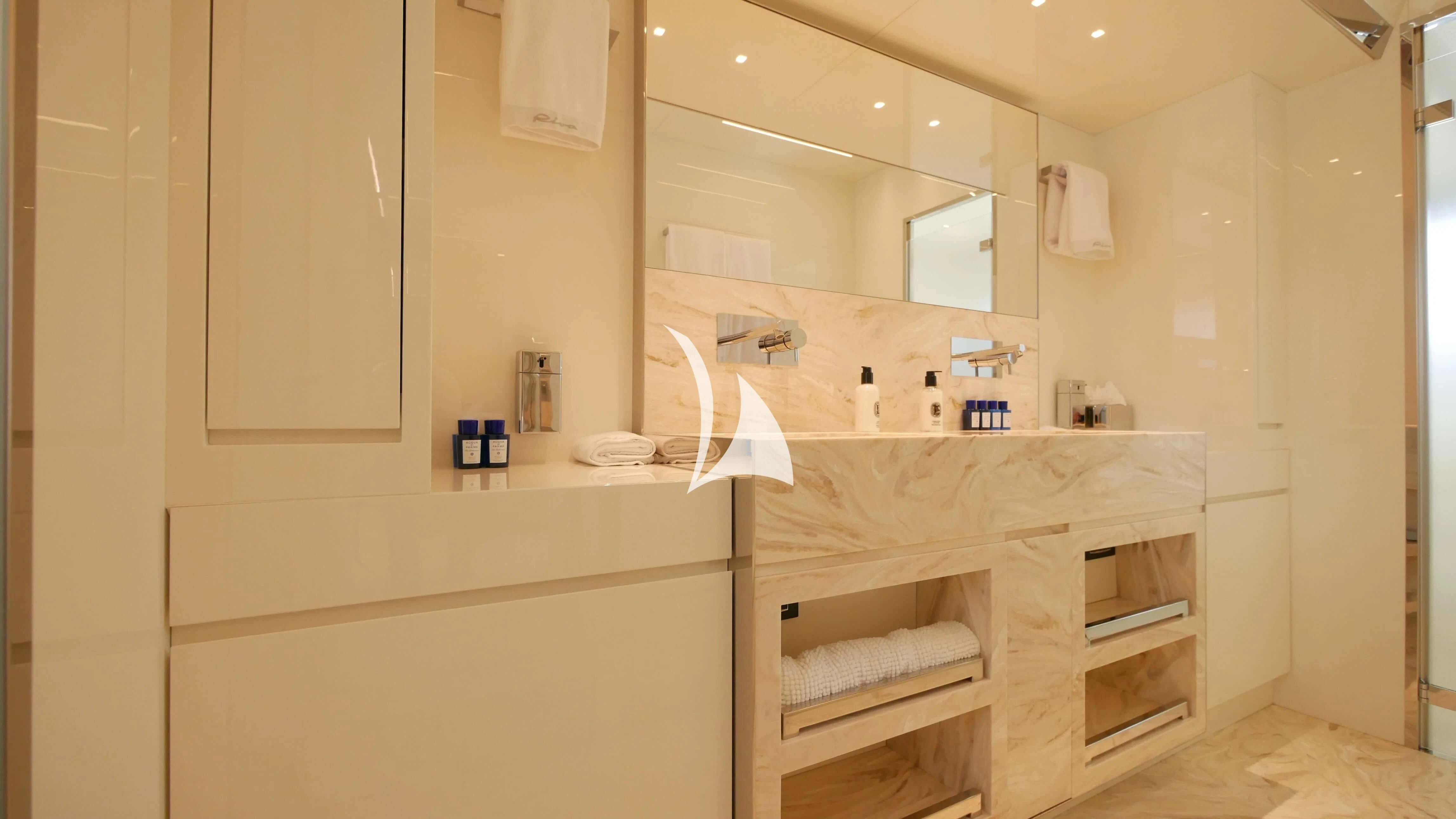 a bathroom with a large mirror aboard BASILIC Yacht for Sale