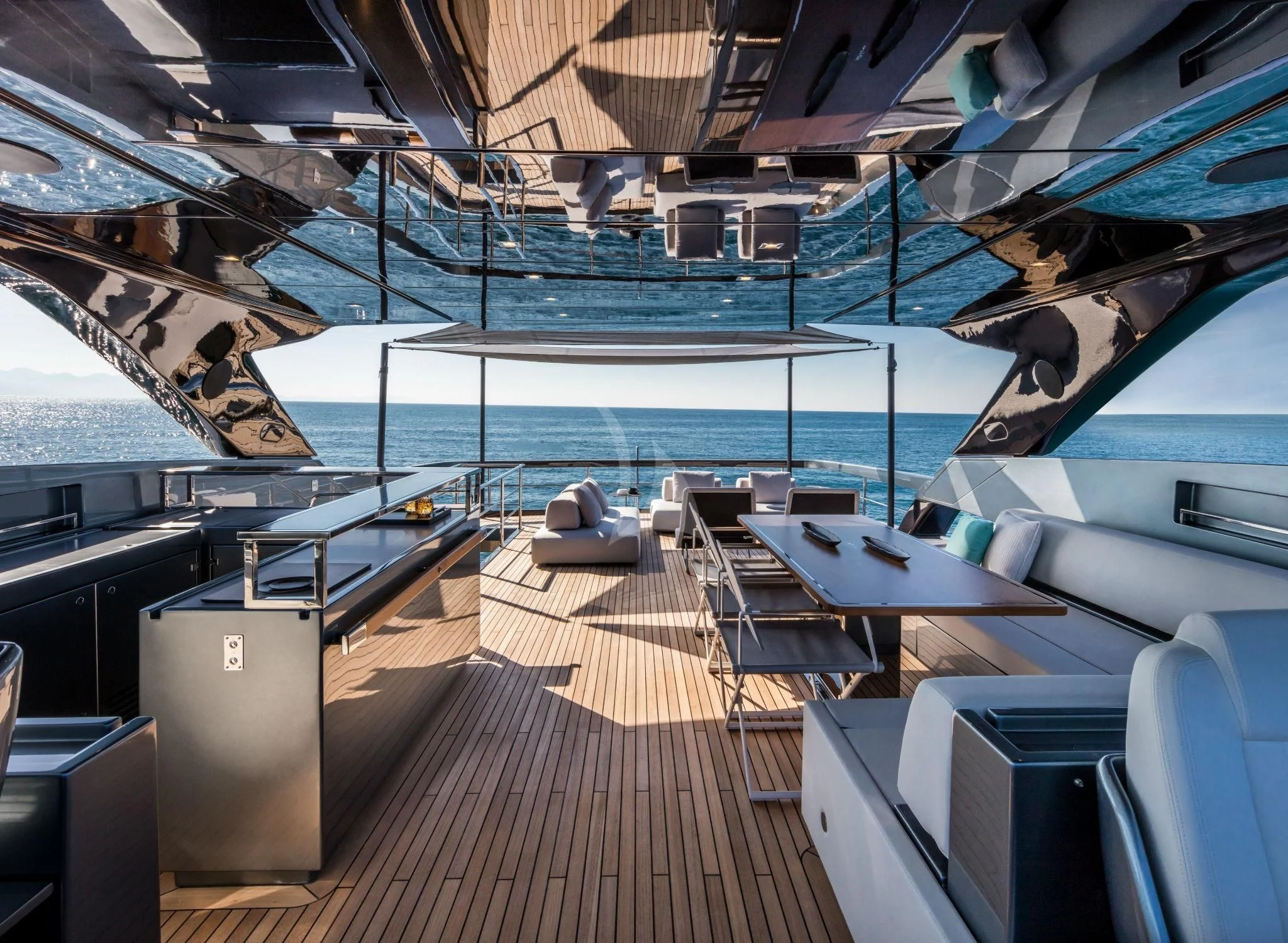 a deck with a deck and chairs aboard BASILIC Yacht for Sale