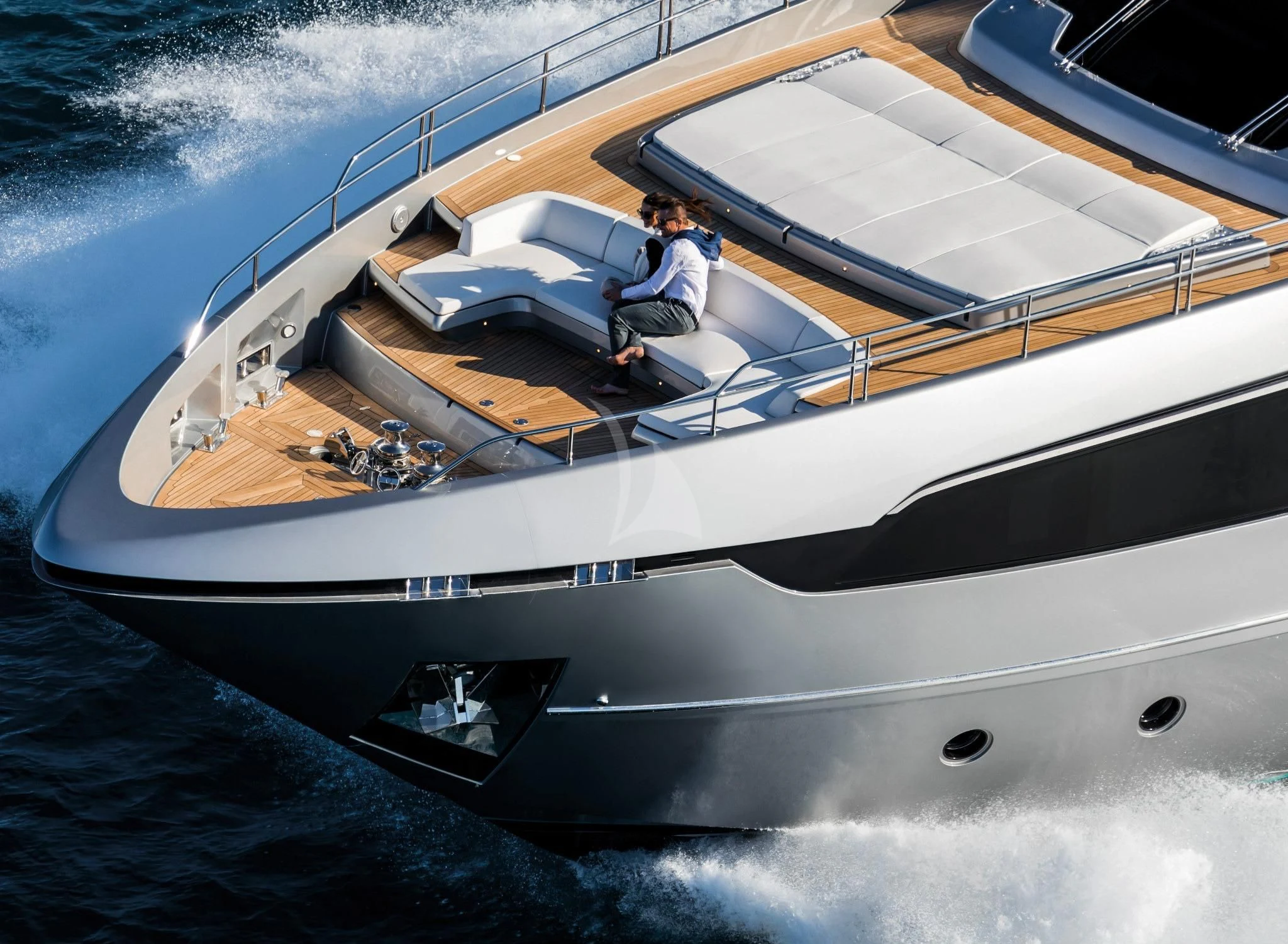 a man and woman sitting on a boat aboard BASILIC Yacht for Sale