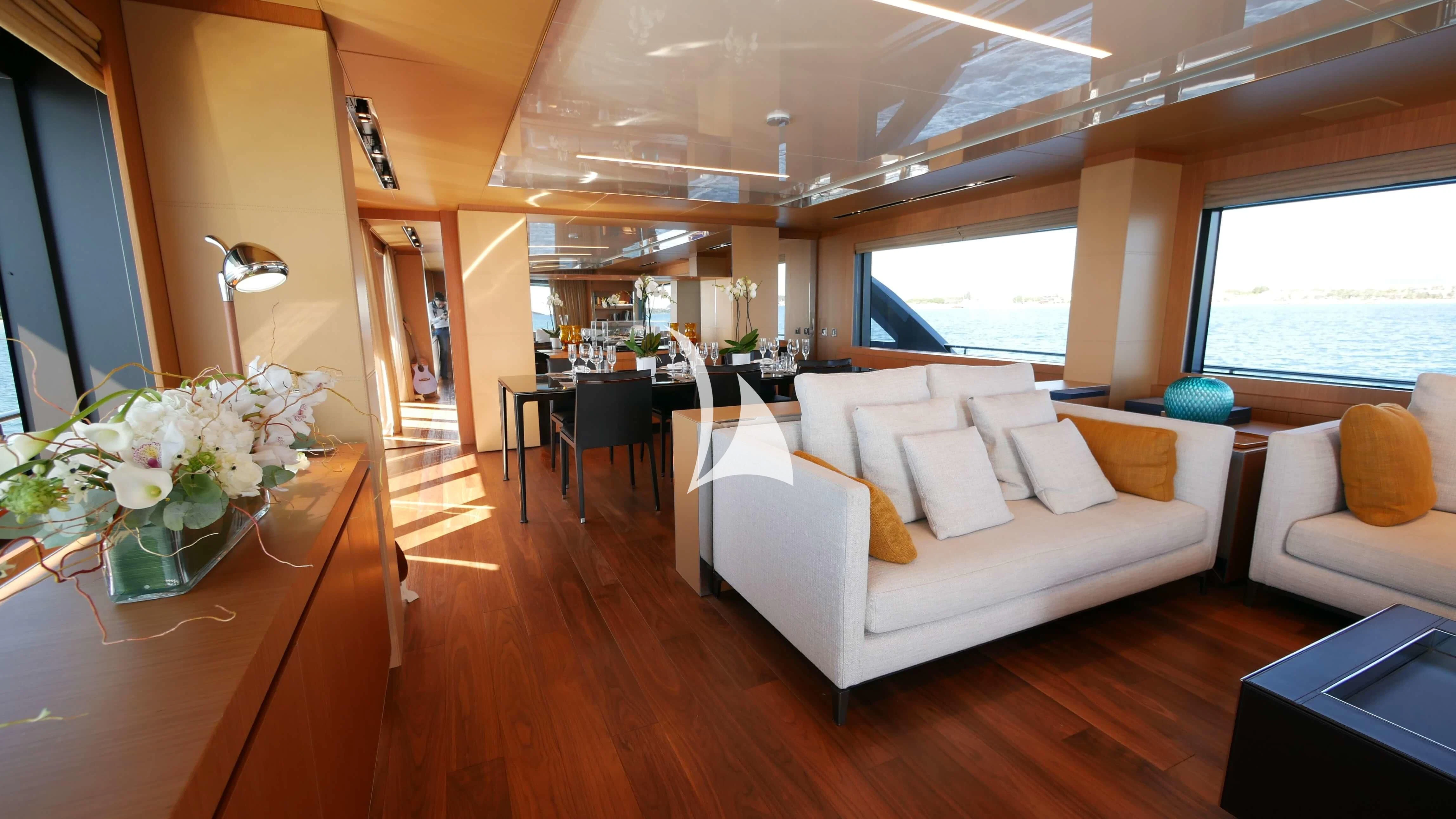 a living room with a couch and a table aboard BASILIC Yacht for Sale