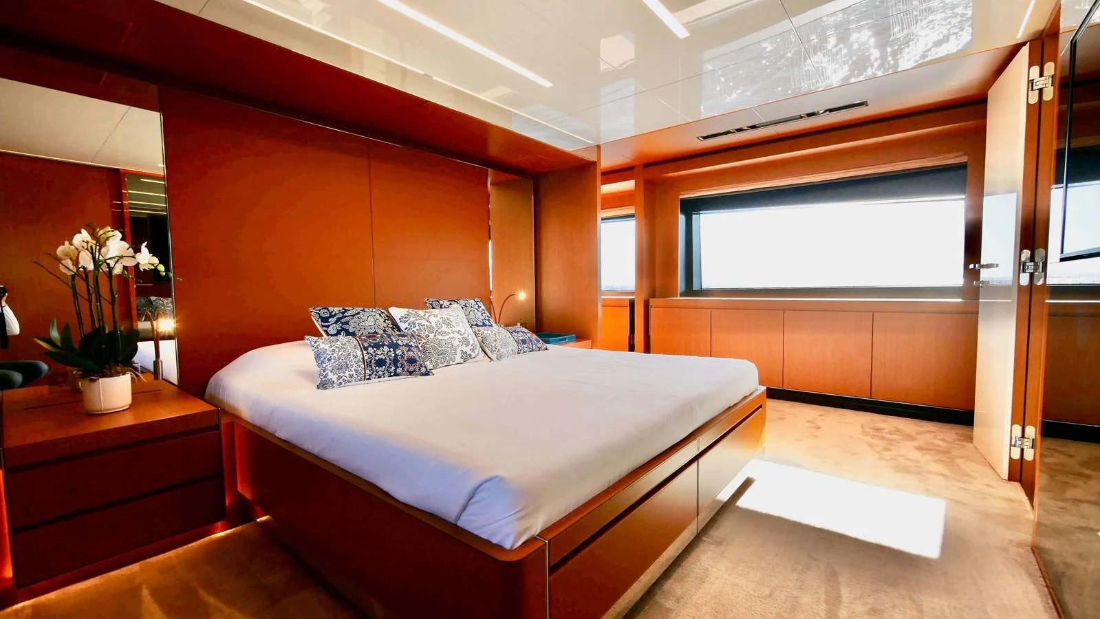 a bedroom with a bed and a desk aboard BASILIC Yacht for Sale