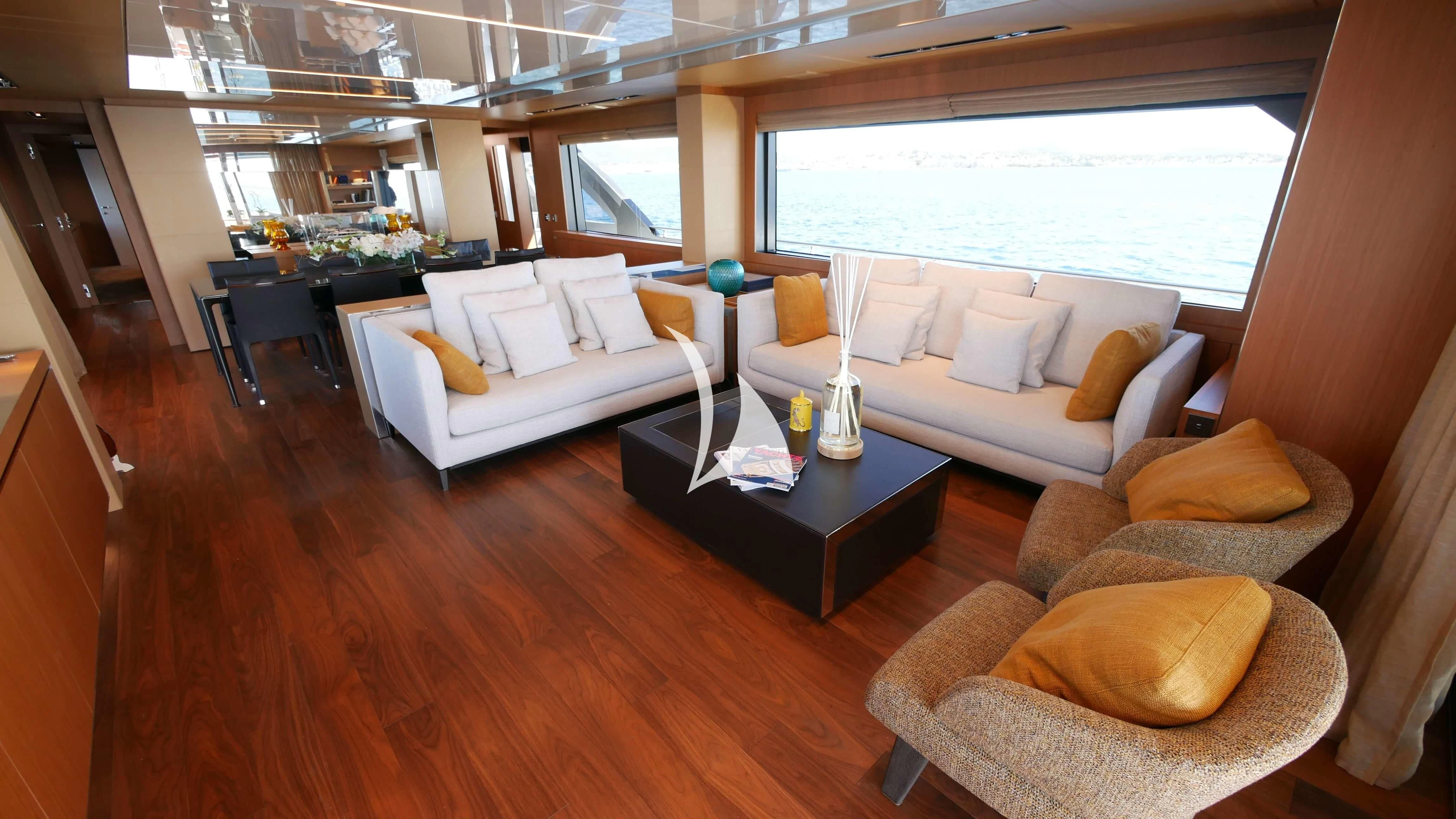 a living room with a couch and a coffee table aboard BASILIC Yacht for Sale