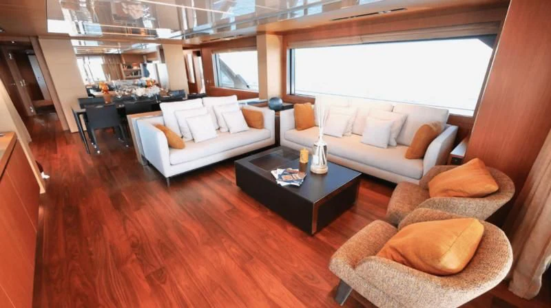 a living room with a couch and a coffee table aboard BASILIC Yacht for Sale