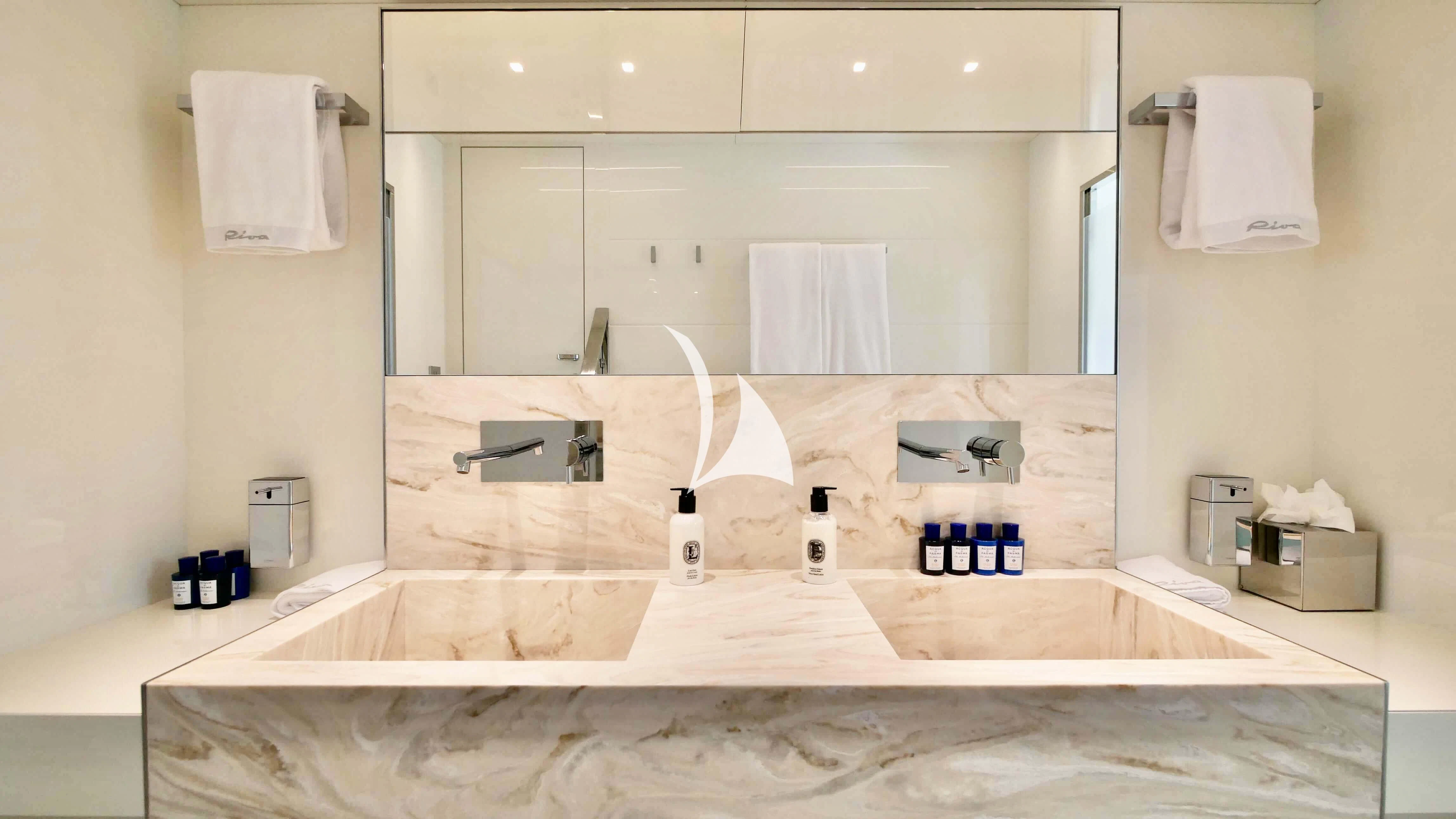 a bathroom with a large mirror aboard BASILIC Yacht for Sale