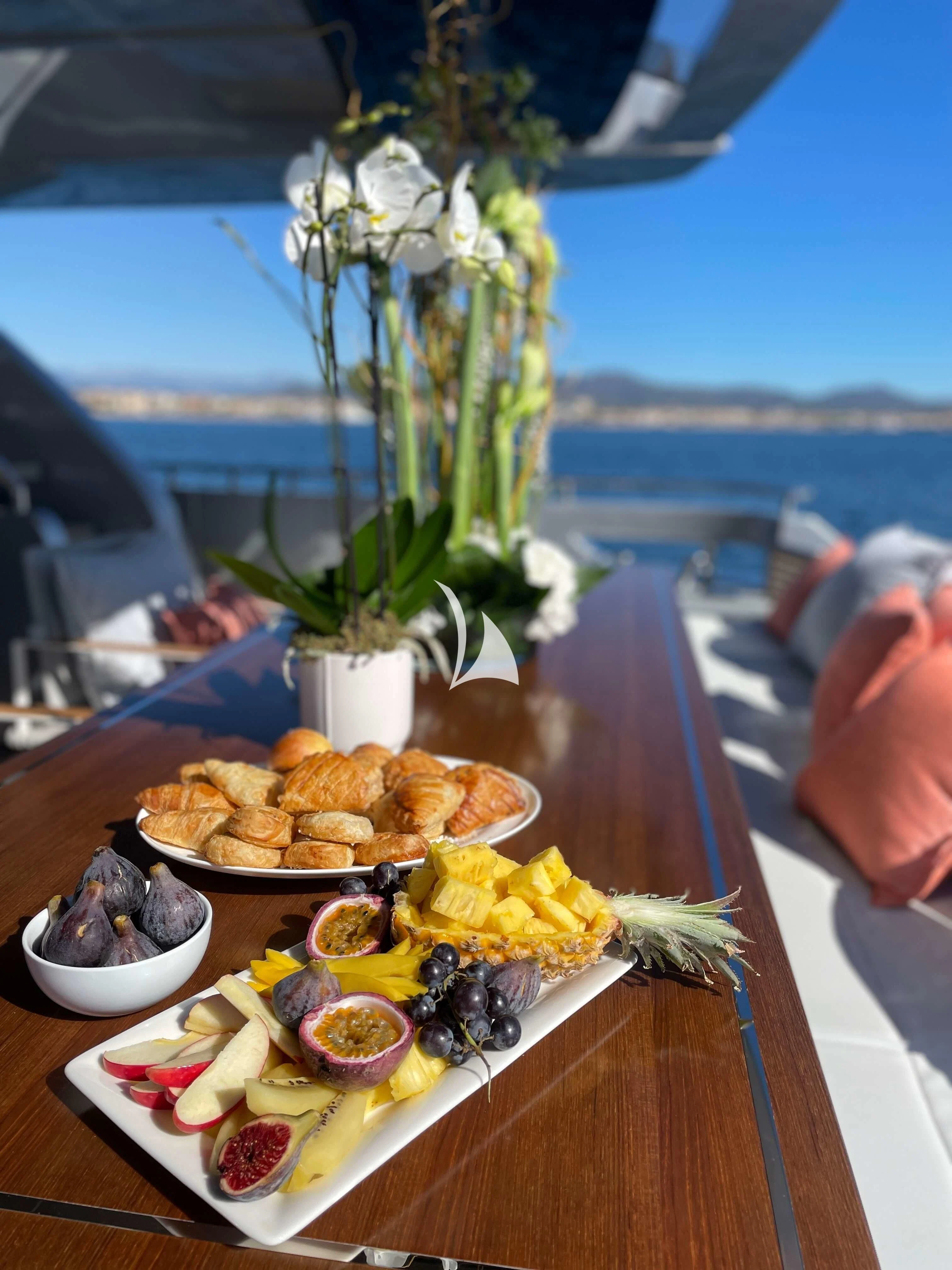 a table with food on it aboard BASILIC Yacht for Sale