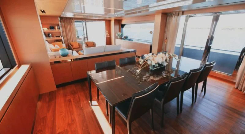 a dining table in a room aboard BASILIC Yacht for Sale