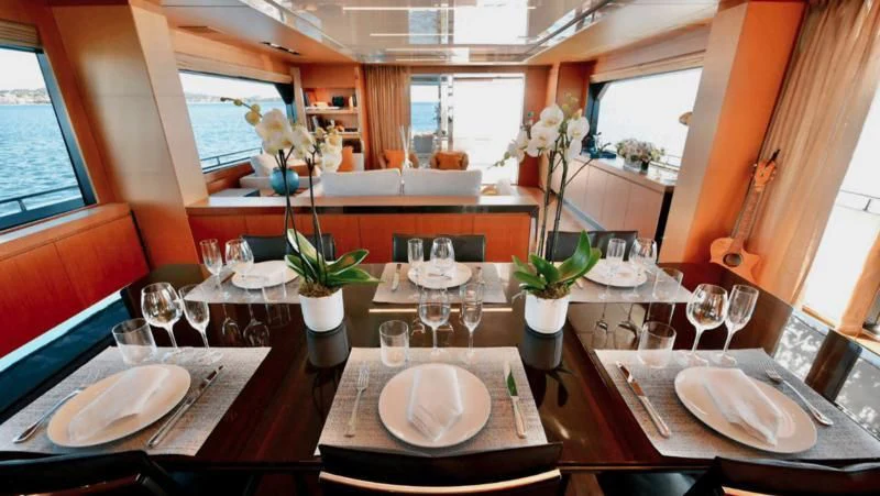 a table with plates and glasses aboard BASILIC Yacht for Sale
