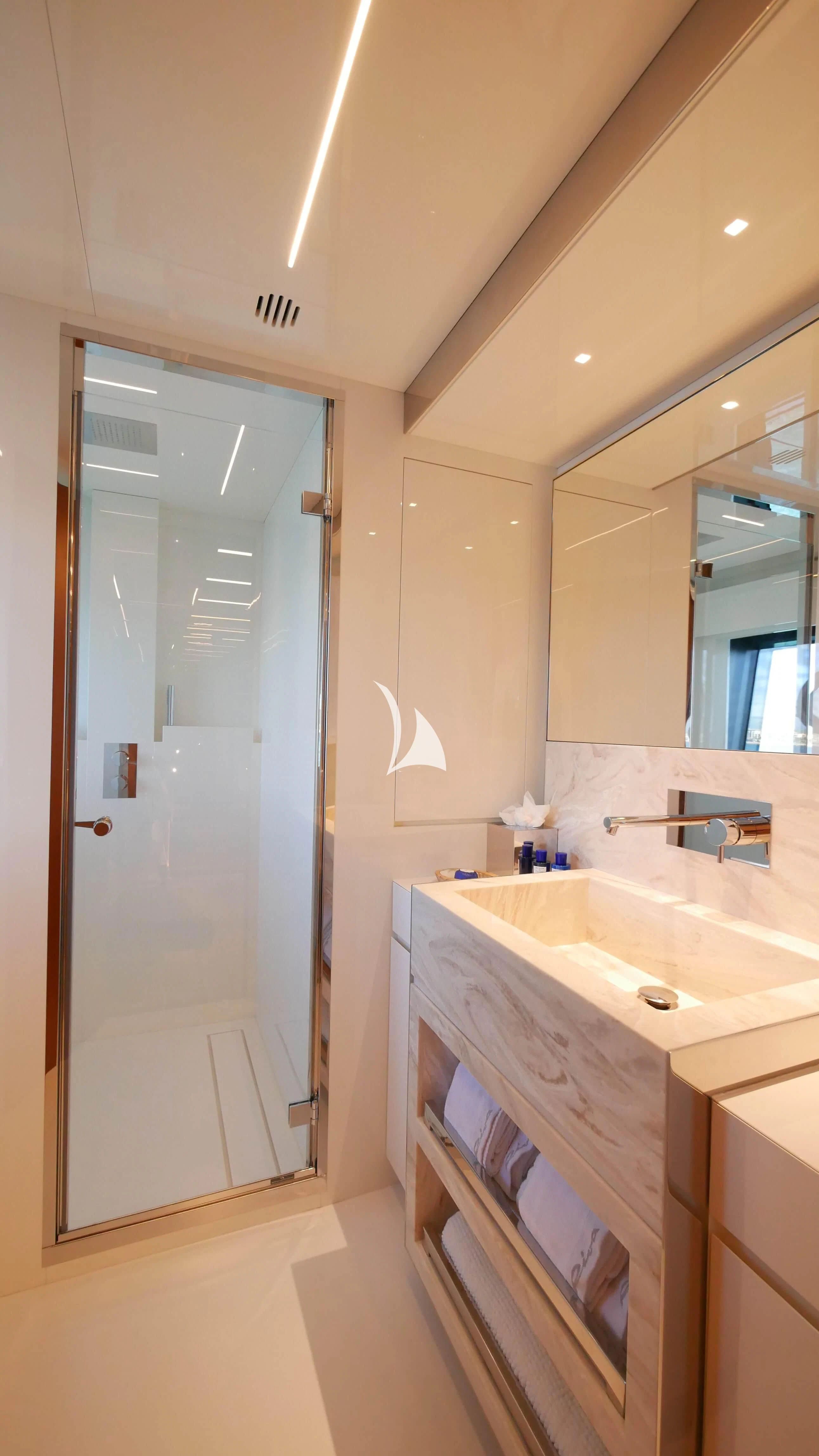 a bathroom with a sink and a mirror aboard BASILIC Yacht for Sale