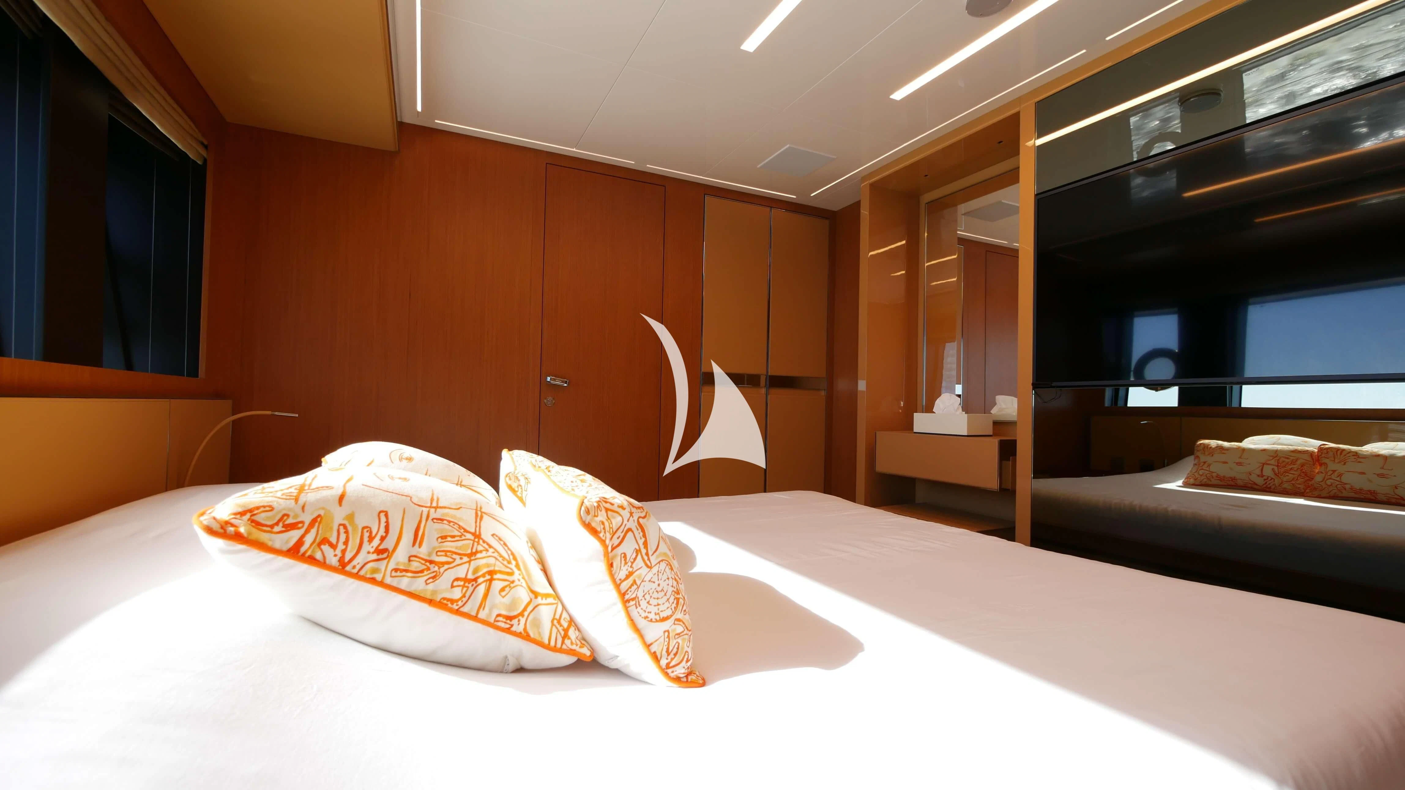 a room with a bed and a mirror aboard BASILIC Yacht for Sale
