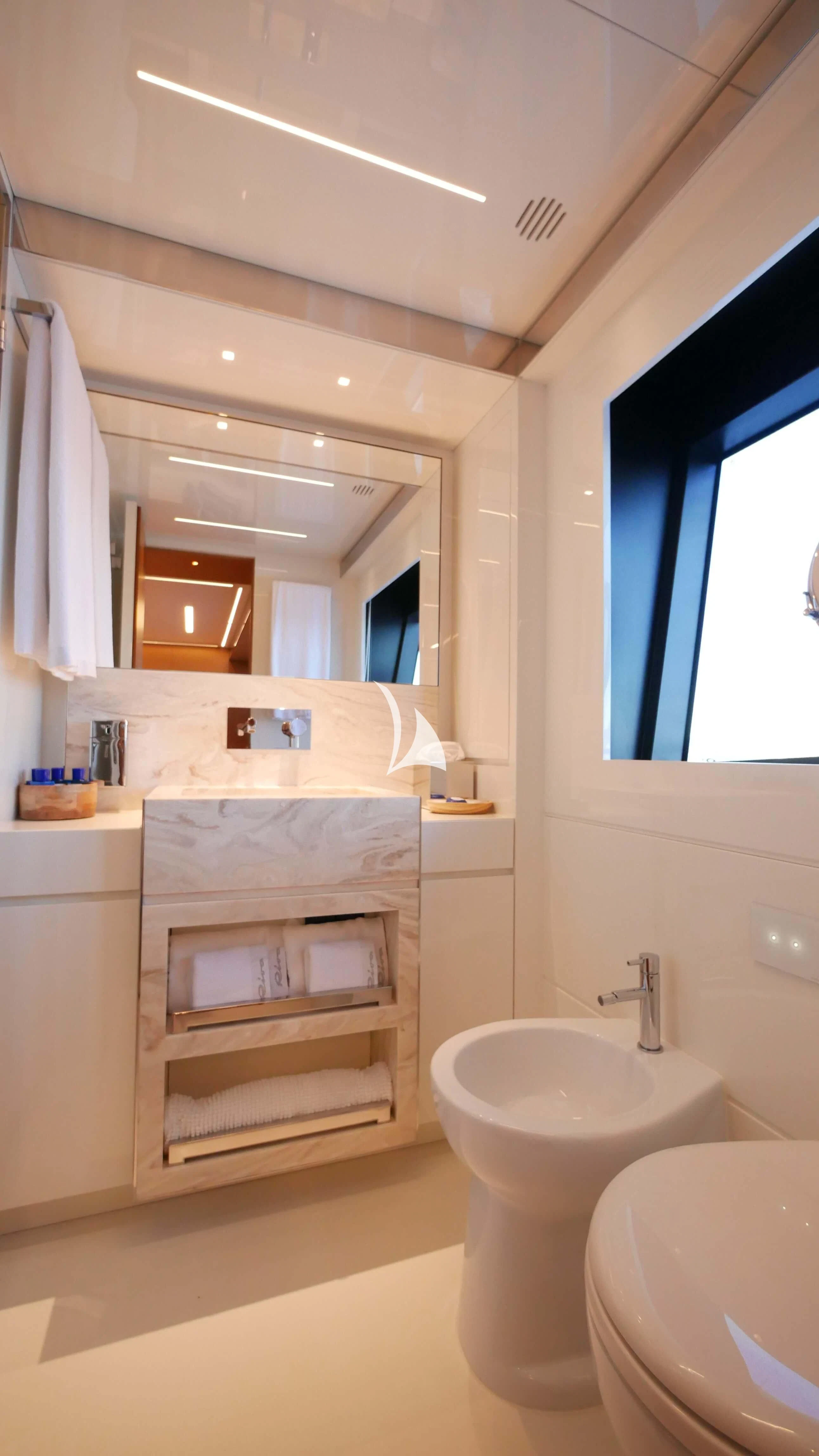 a bathroom with a sink and a mirror aboard BASILIC Yacht for Sale