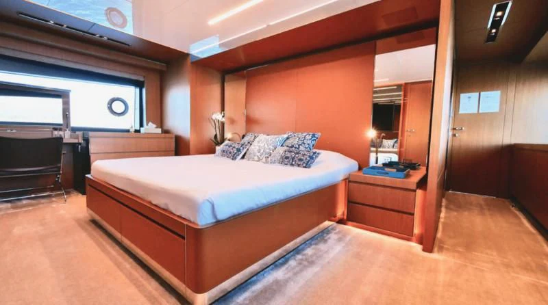 a bedroom with a bed aboard BASILIC Yacht for Sale