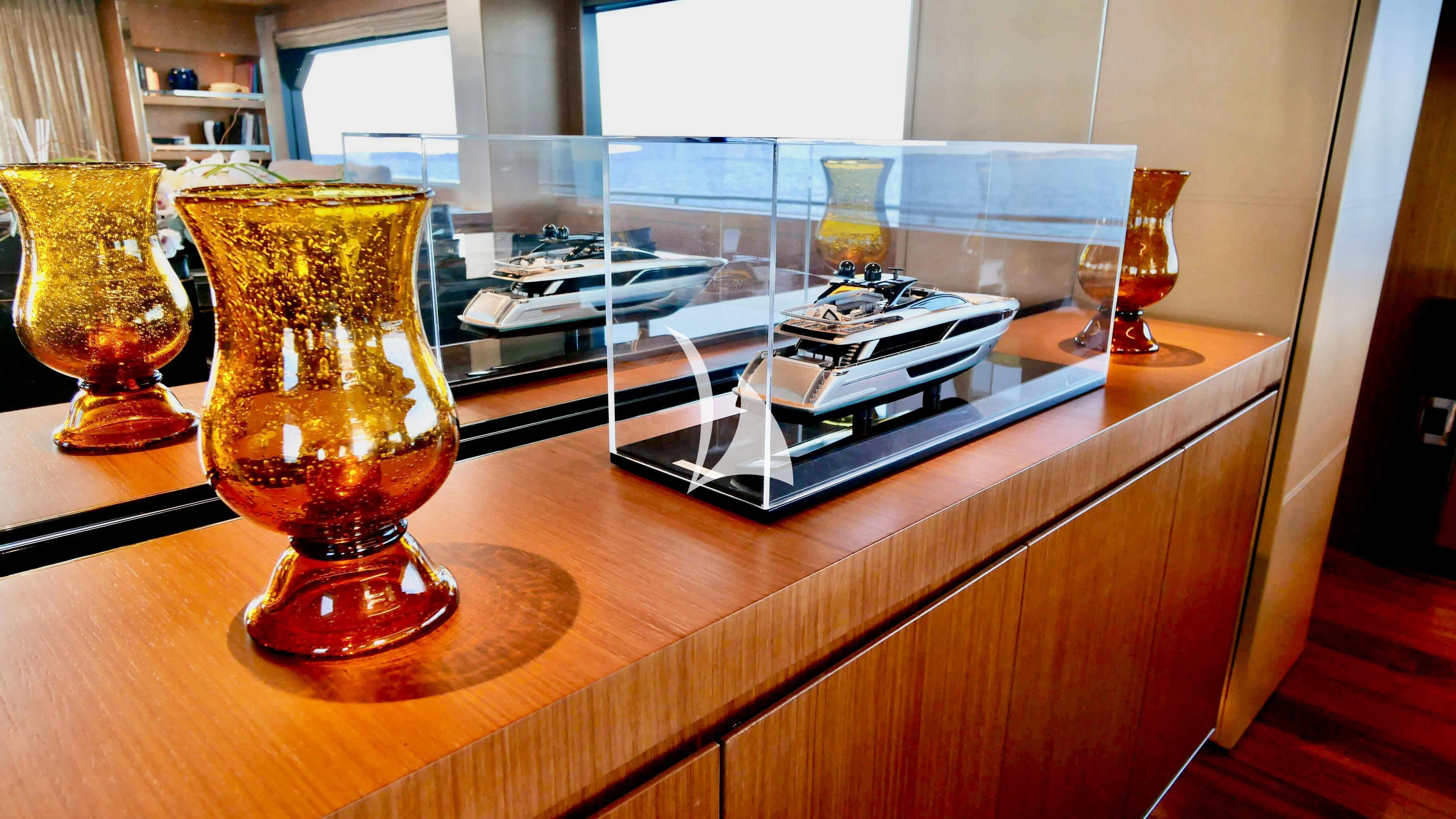 a glass of liquid next to a candle and a glass of liquid aboard BASILIC Yacht for Sale
