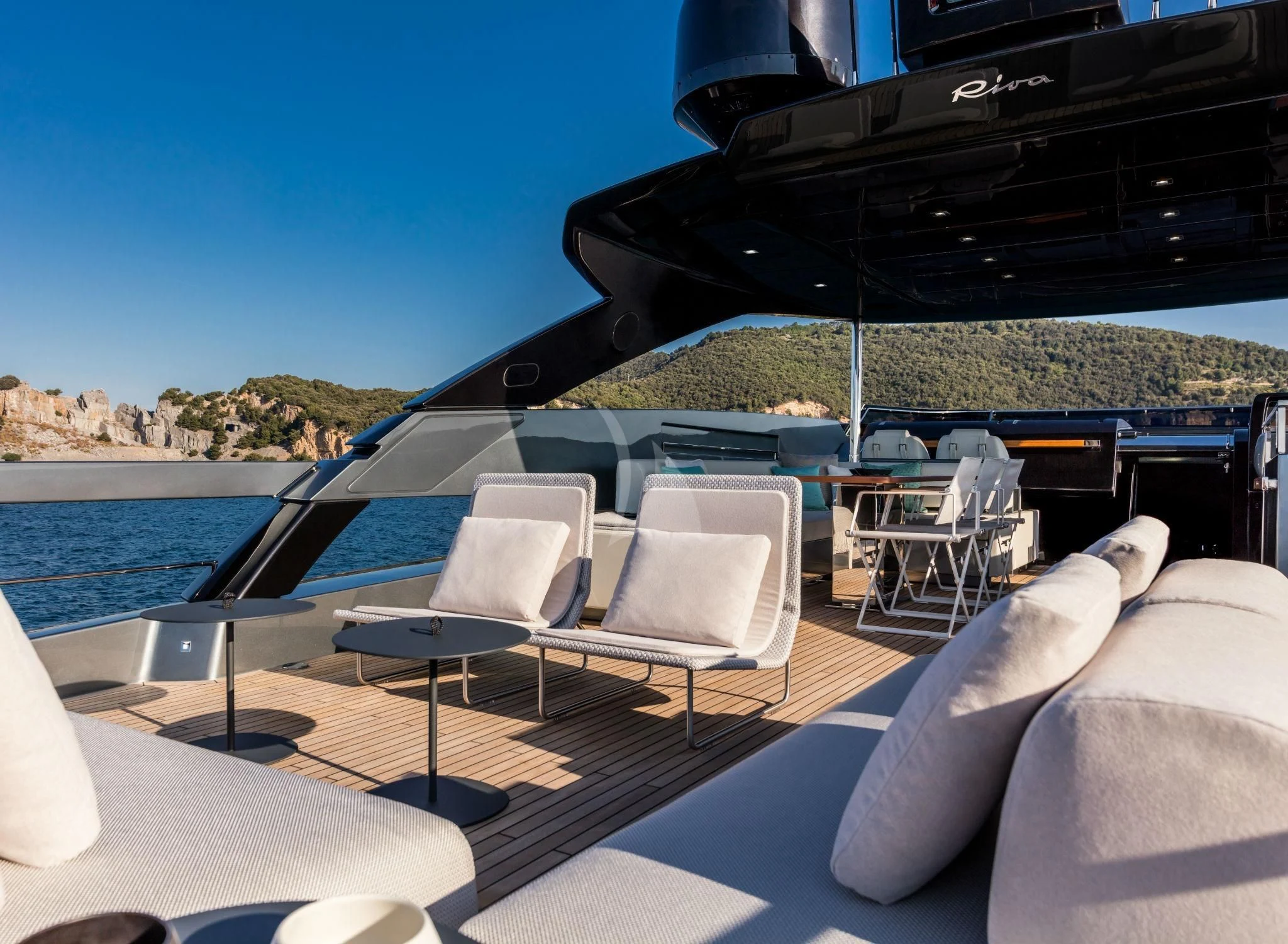 a lounge chair on a deck overlooking a large body of water aboard BASILIC Yacht for Sale