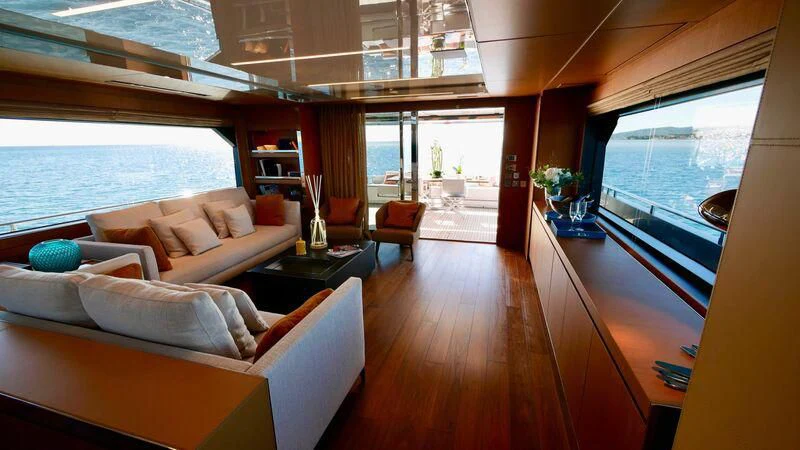 a living room with a wood floor aboard BASILIC Yacht for Sale