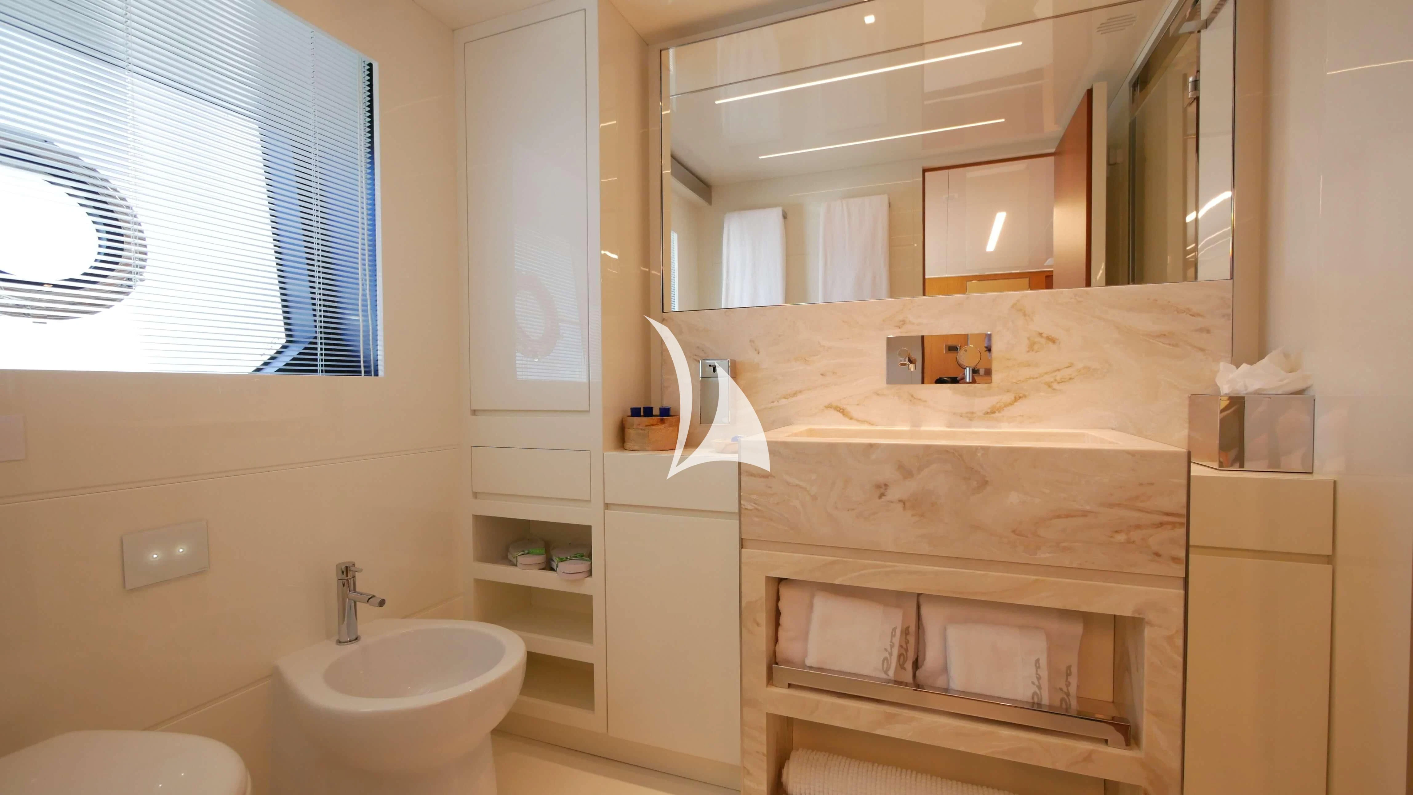 a bathroom with a sink and a mirror aboard BASILIC Yacht for Sale