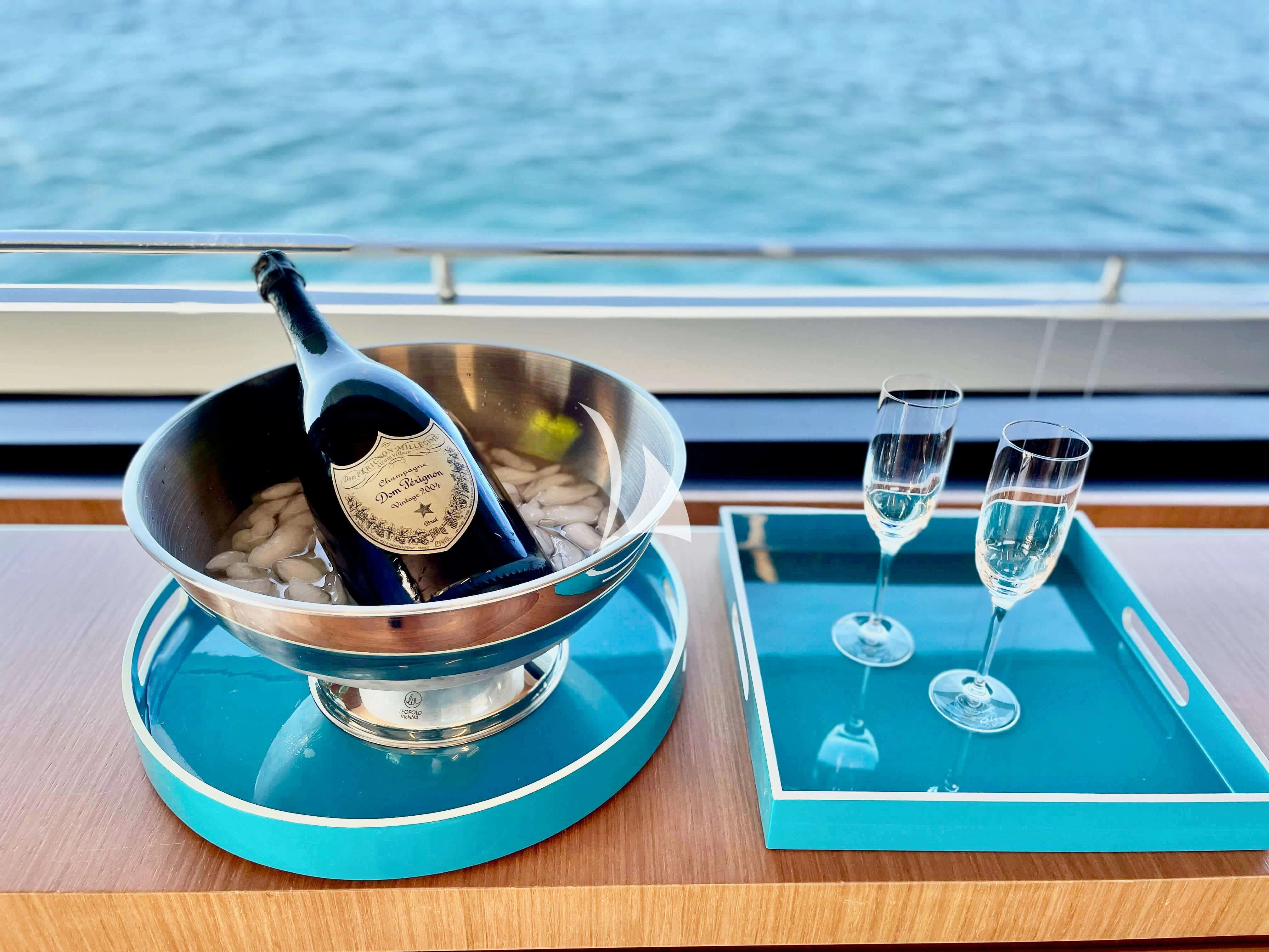 a bowl of ice cream on a table by a window aboard BASILIC Yacht for Sale