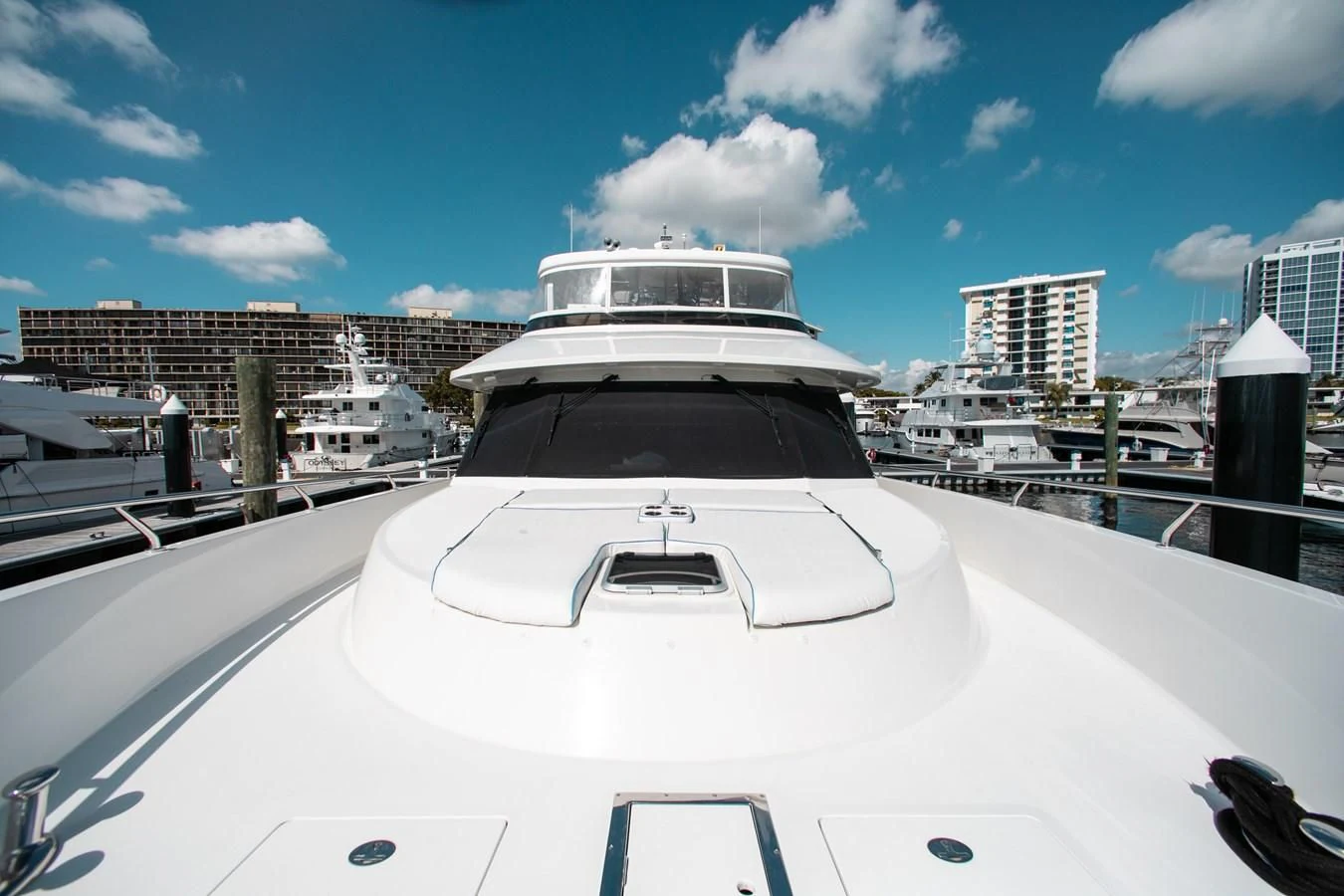 a white yacht in a harbor aboard TRINITY Yacht for Sale