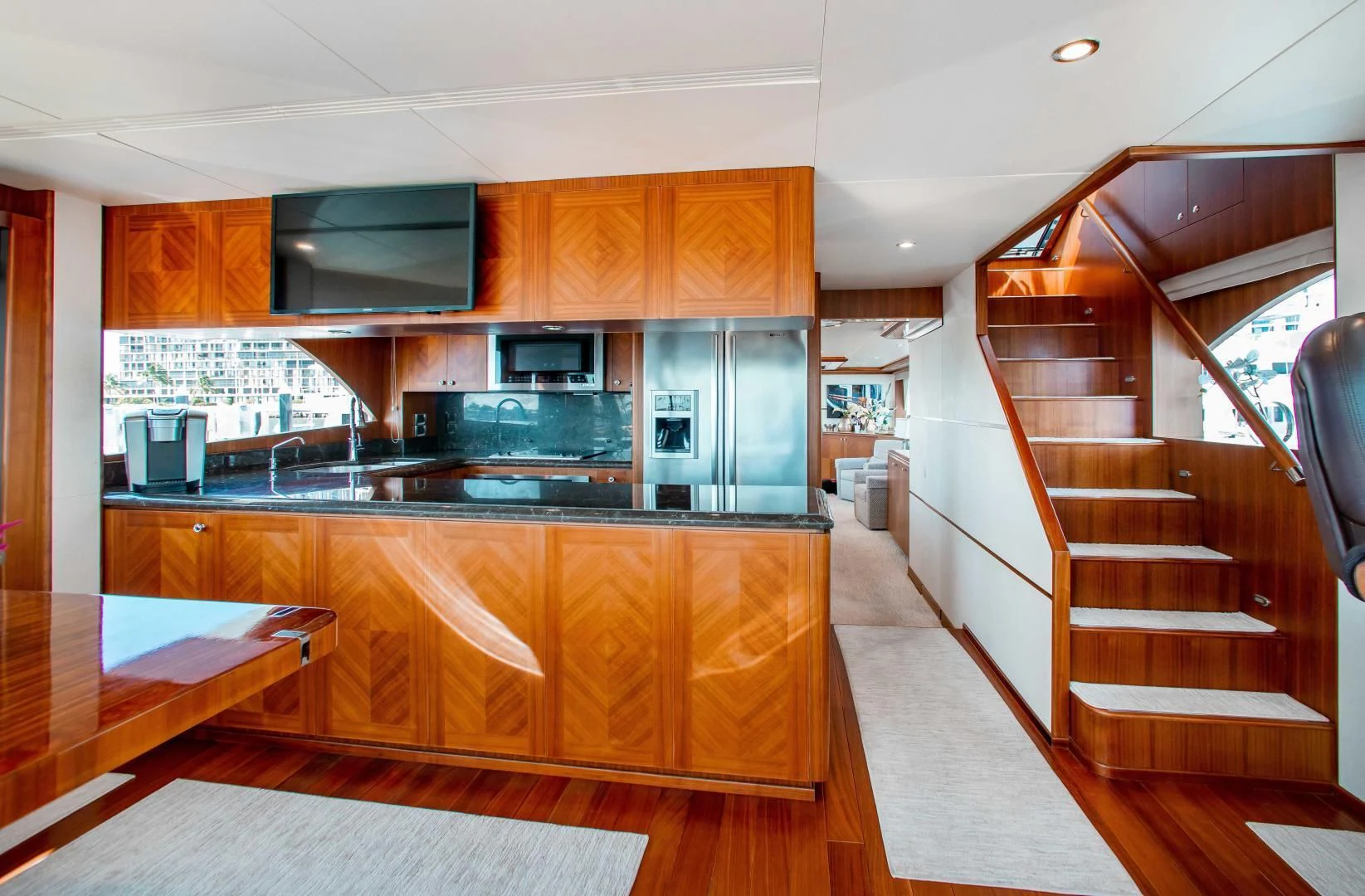a kitchen with wooden cabinets aboard TRINITY Yacht for Sale