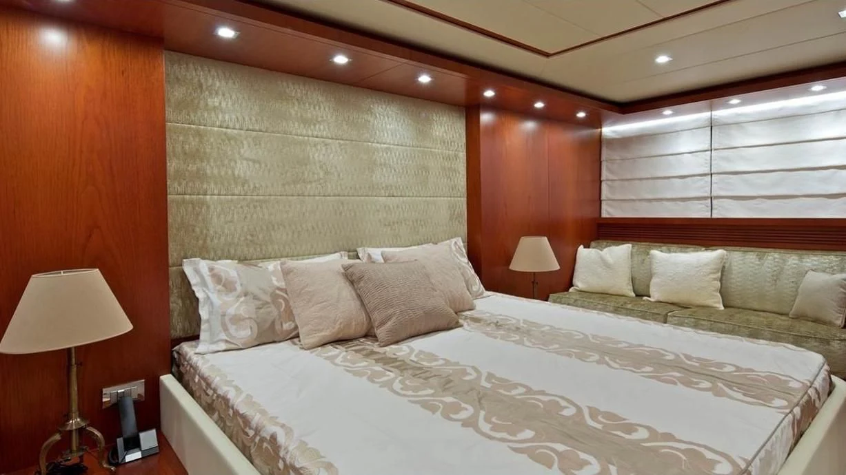 a large bed with a white bed aboard BIANCA Yacht for Sale