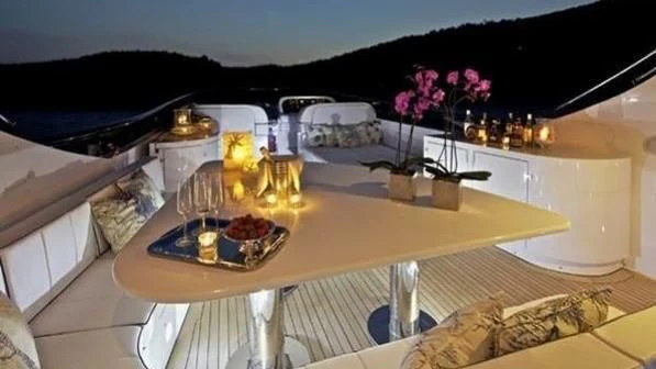 a table with a glass and a tray with food on it aboard BIANCA Yacht for Sale