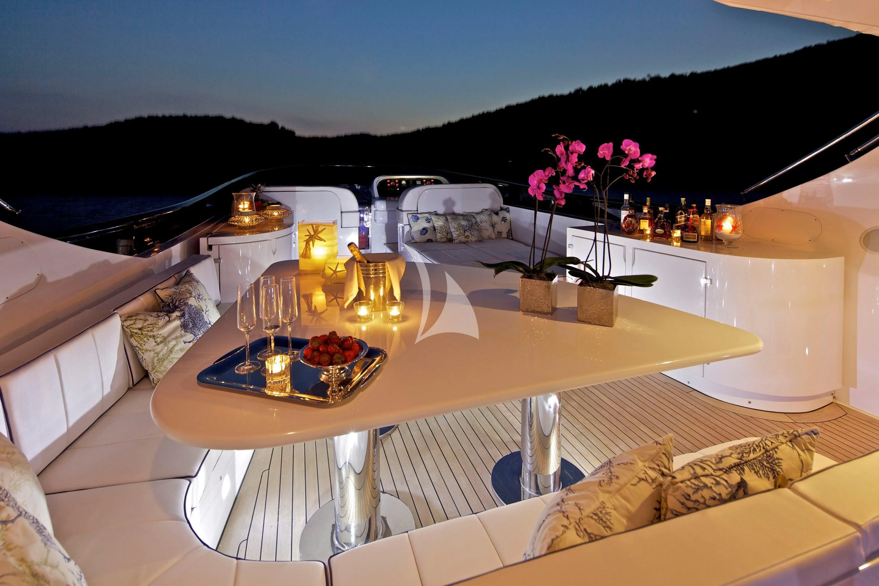 a table with candles and flowers on it aboard BIANCA Yacht for Sale
