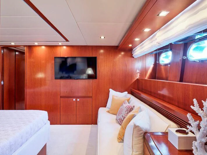 a room with a bed and a television on the wall aboard BIANCA Yacht for Sale