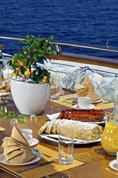 a table with food and drinks on it aboard BIANCA Yacht for Sale
